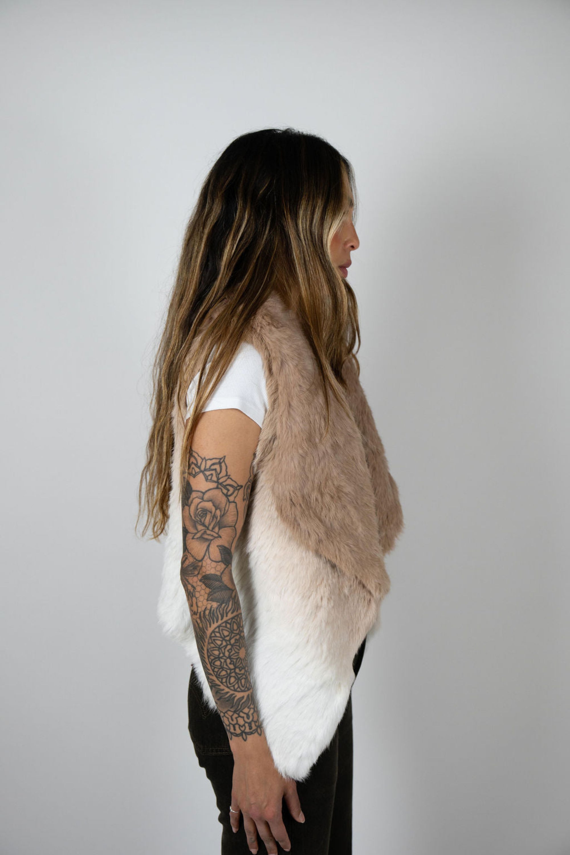 Side profile of model wearing beige ombre rabbit vest