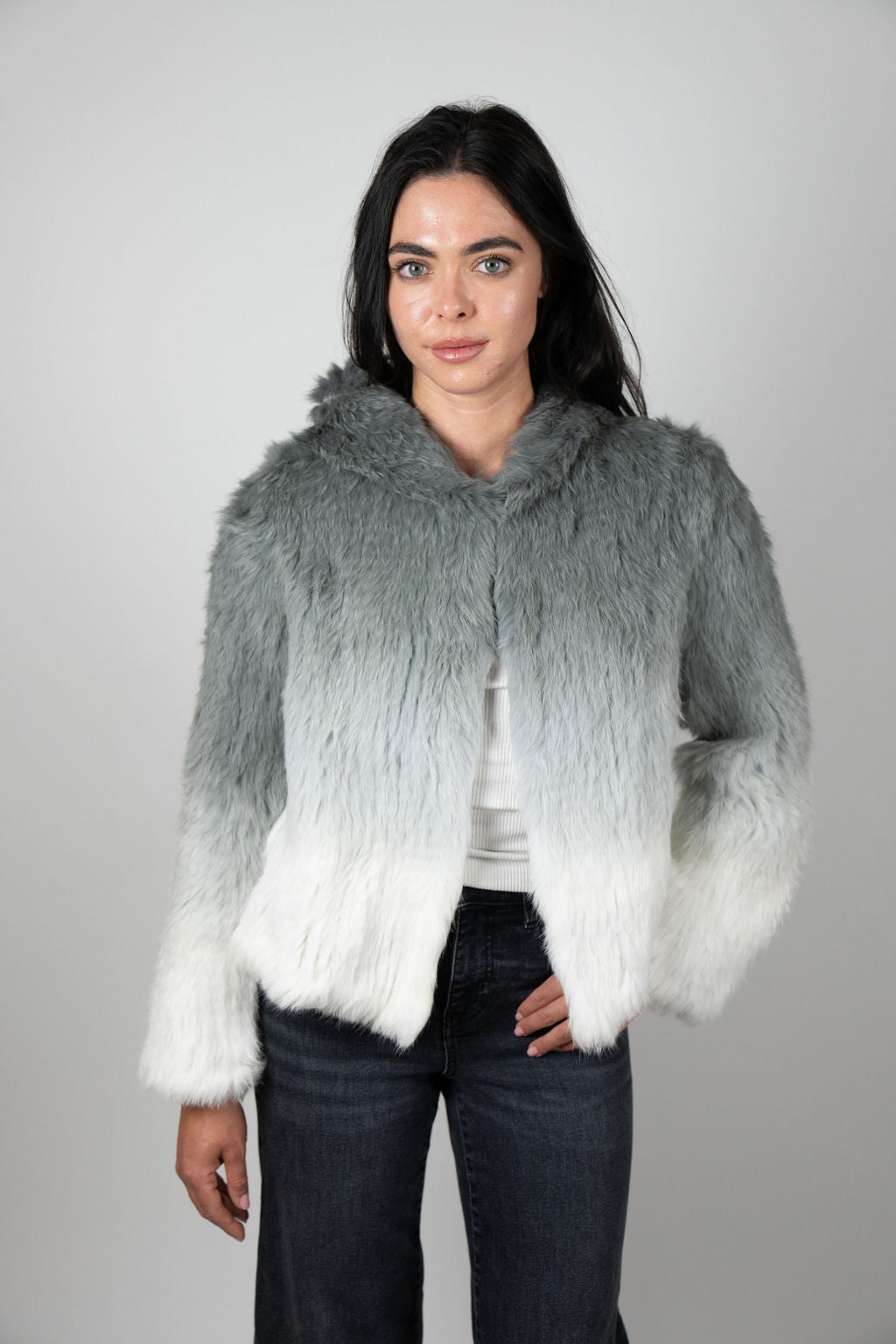 Profile view of grey ombre rabbit fur crop jacket with hoodie detail