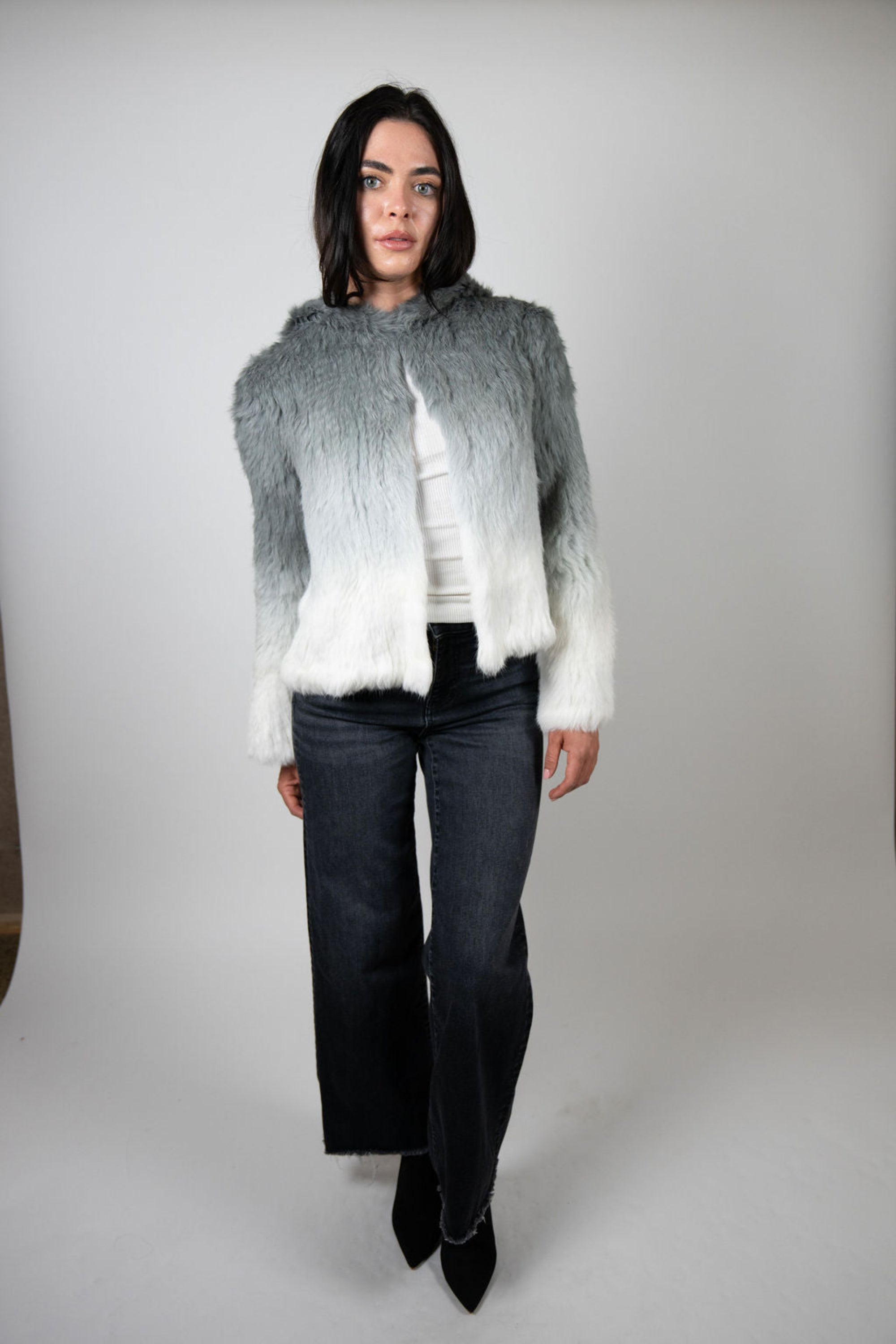 Full front view of grey ombre rabbit fur crop jacket styled with wide-leg jeans