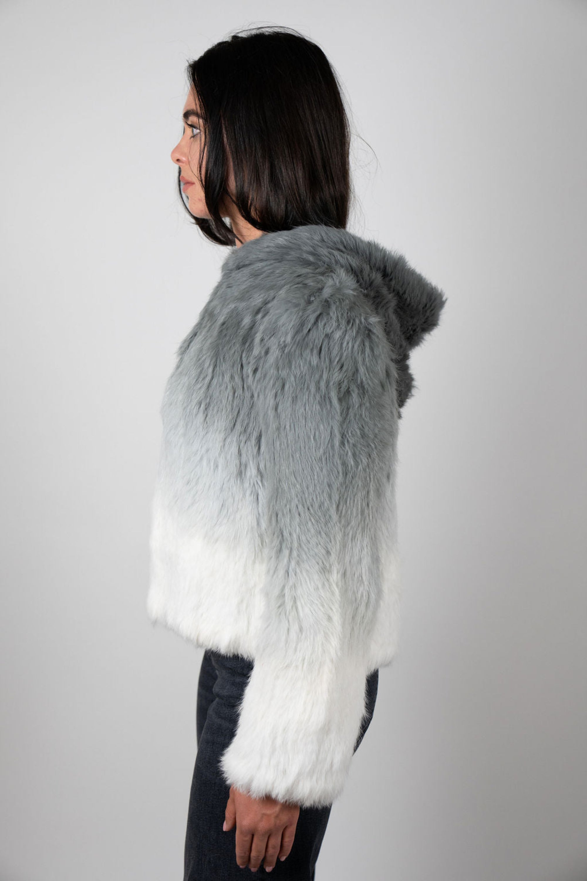 Side view of grey ombre rabbit fur hooded crop jacket on model
