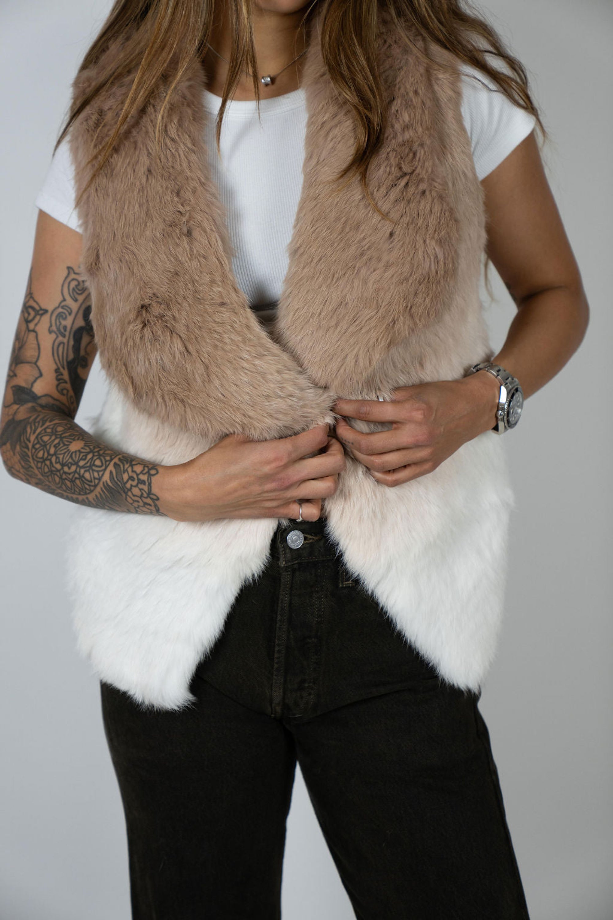 Close-up of rabbit fur ombre vest showing clasp detail and texture