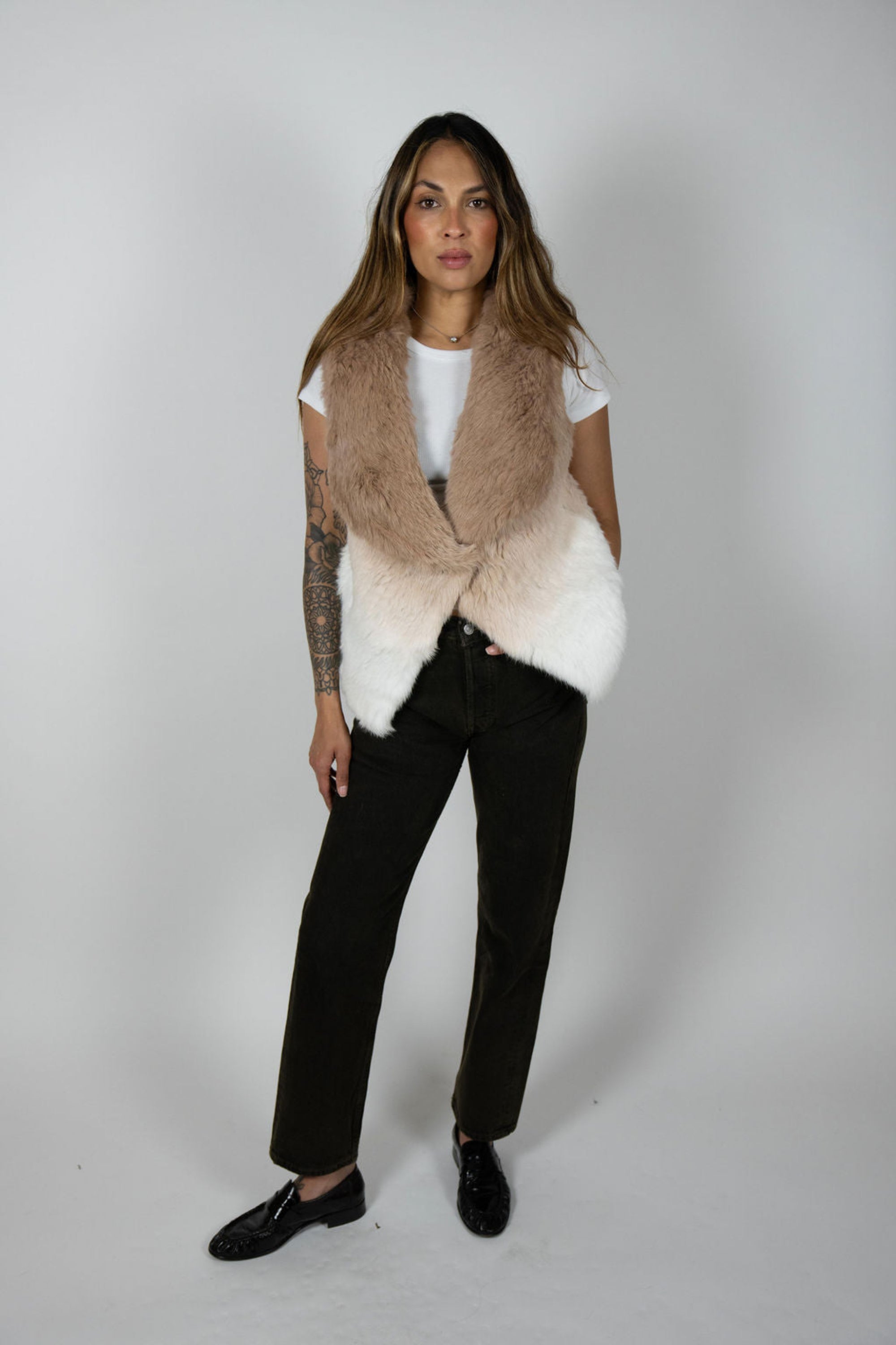 Model wearing rabbit fur ombre vest in beige and white, front angle view