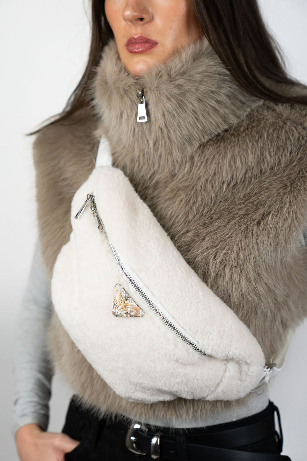 Model wearing the Alpine crossbody bag in Snow by Angel Wings by Lucy, a compact luxury accessory designed for elevated winter and resort wear.