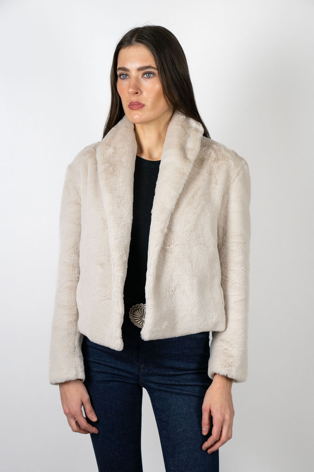Model wearing the Bear Den Crop Jacket in Beige by Angel Wings by Lucy, a luxury faux fur cropped jacket designed for versatile winter styling.