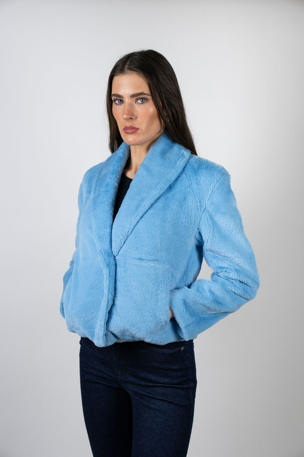 Model wearing the Bear Den Crop Jacket in Sky by Angel Wings by Lucy, a luxury faux fur cropped jacket designed for elevated winter styling.