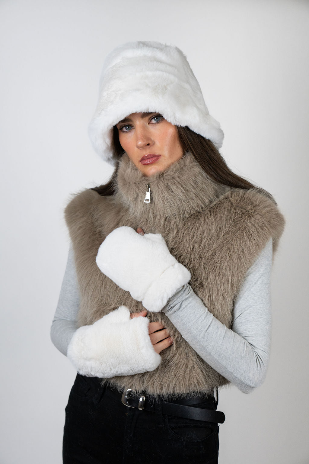Model wearing faux fur gloves in White by Angel Wings by Lucy, a luxury winter accessory designed for elevated cold-weather styling.