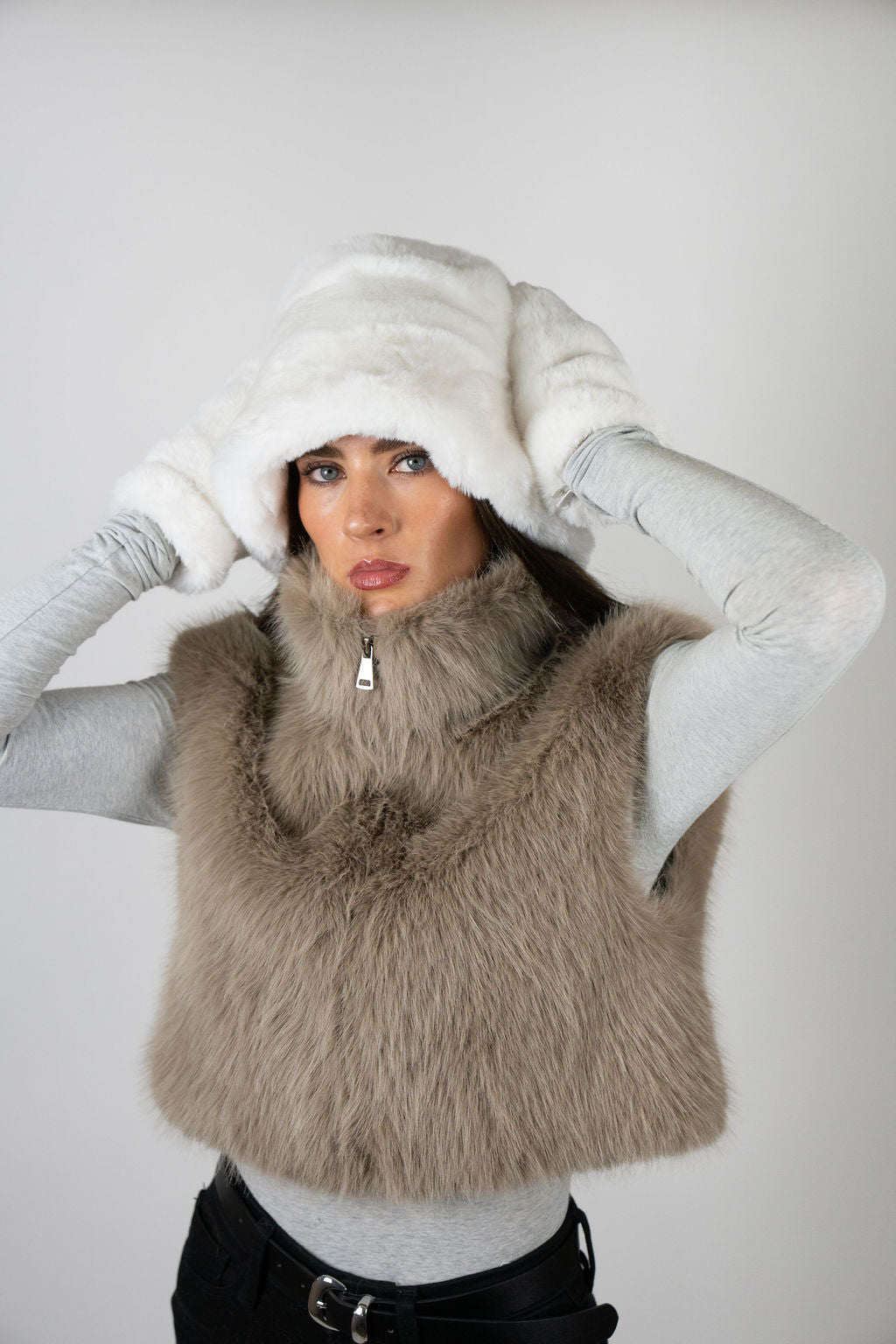 Model wearing faux fur gloves in White by Angel Wings by Lucy, a luxury winter accessory designed for elevated cold-weather styling.