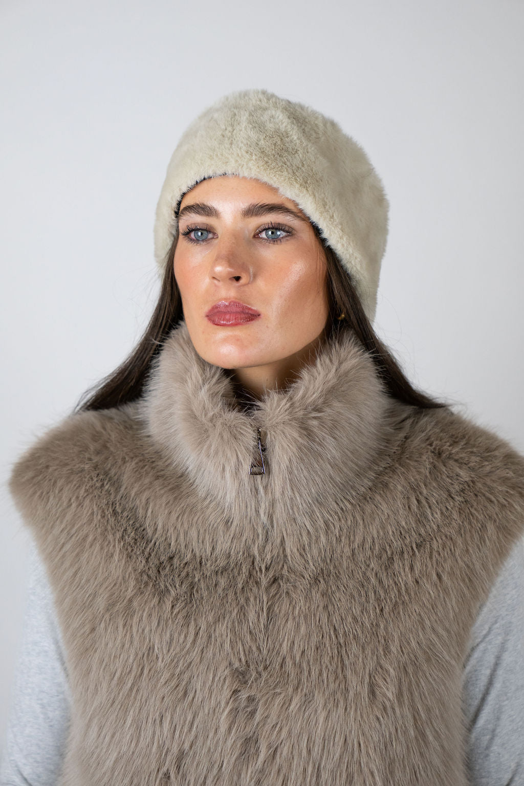 Model wearing the faux fur headband in Beige by Angel Wings by Lucy, styled with a faux fur vest for elevated winter accessorising.