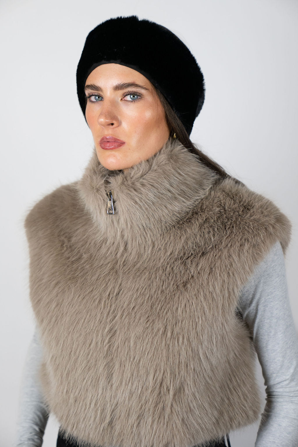 Model wearing the faux fur headband in Black by Angel Wings by Lucy, styled with a faux fur vest for elevated winter accessorising.