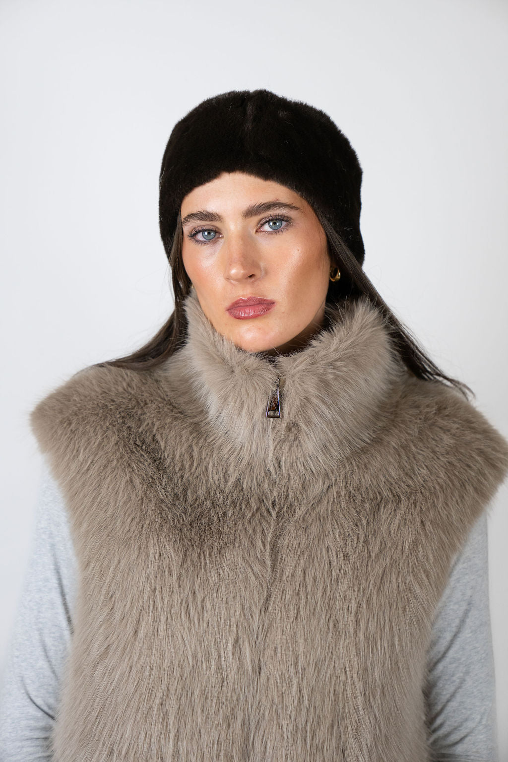 Model wearing the faux fur headband in Chocolate by Angel Wings by Lucy, styled with a faux fur vest for elevated winter accessorising.