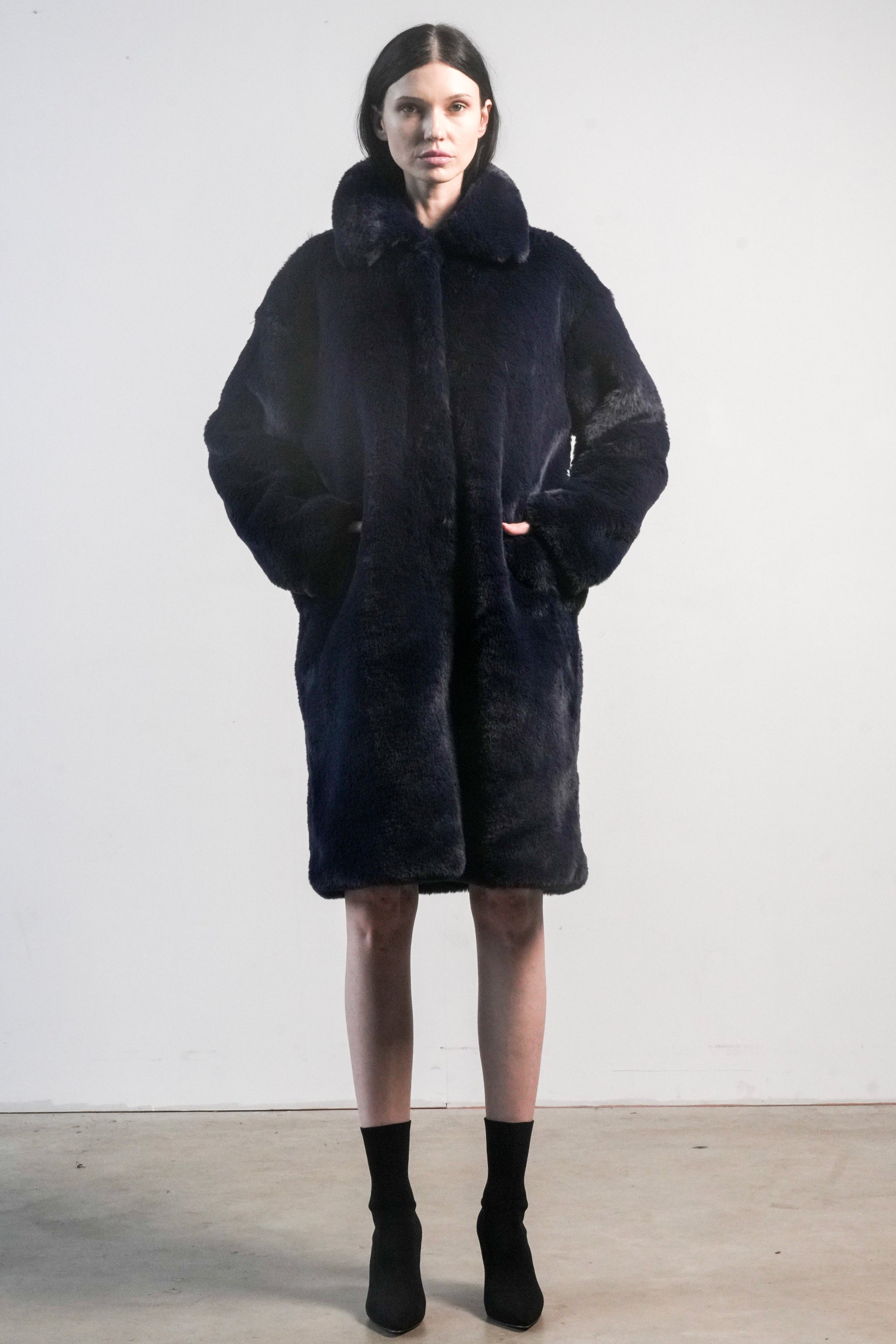 Back view of navy faux fur jacket with white diagonal stripe and bold black “LOVE” lettering — from the Mr. Greys collection.