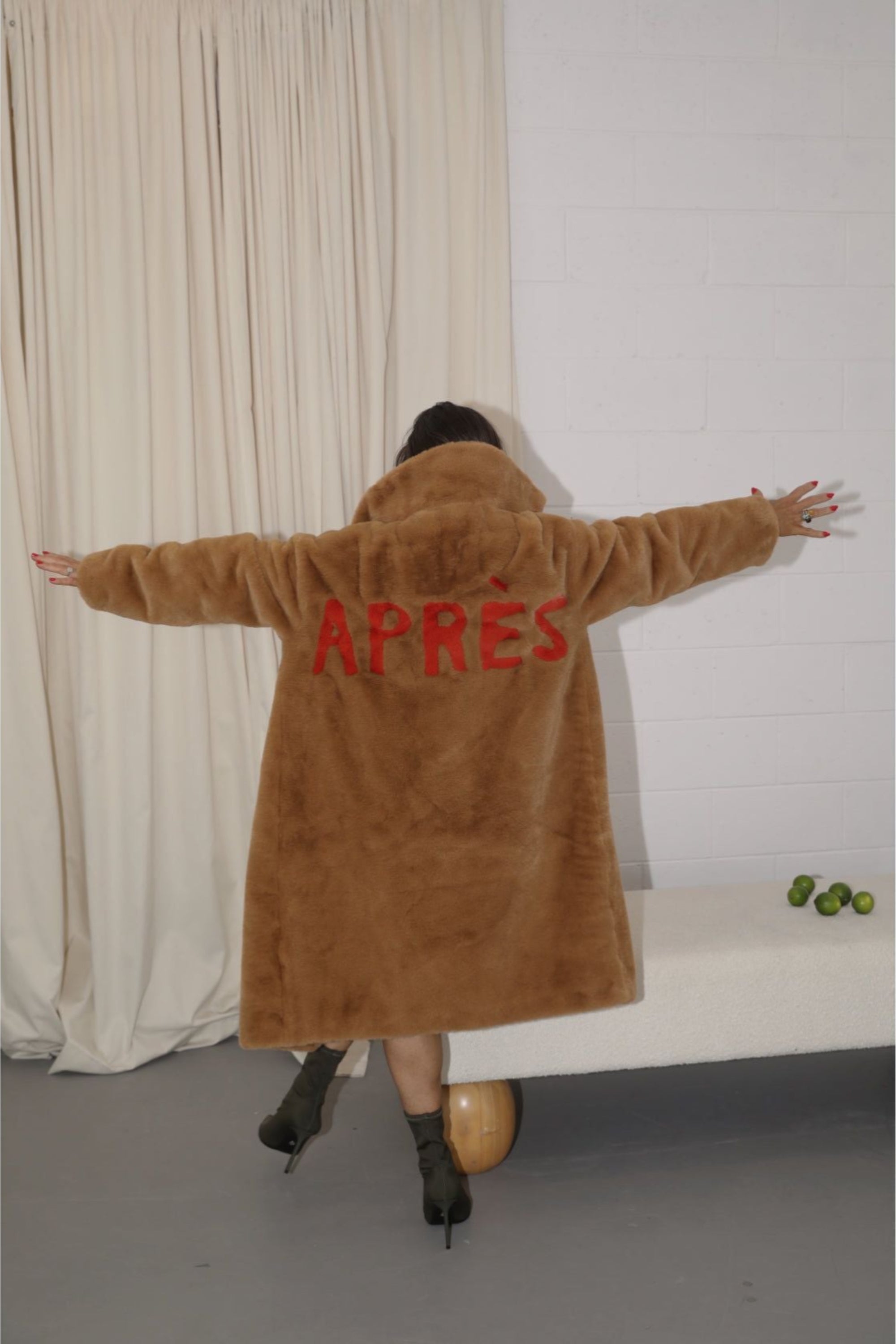Back view of caramel faux fur jacket with bold red “APRÈS” lettering — part of the Mr. Greys après-ski collection.