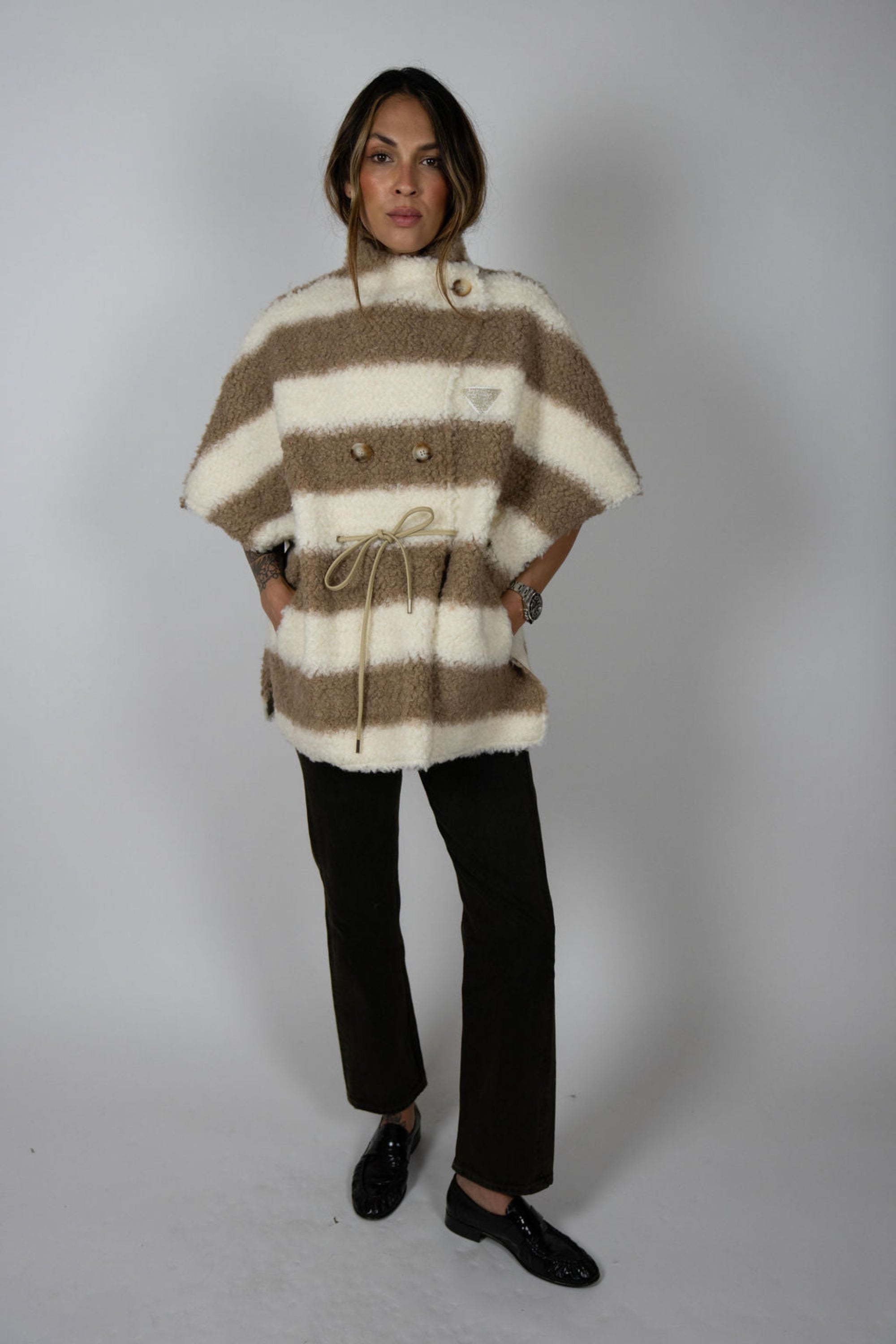 Angel Wings by Lucy wool cape in beige and ivory stripe, oversized with short sleeves, drawstring waist, and buttons, shown on model