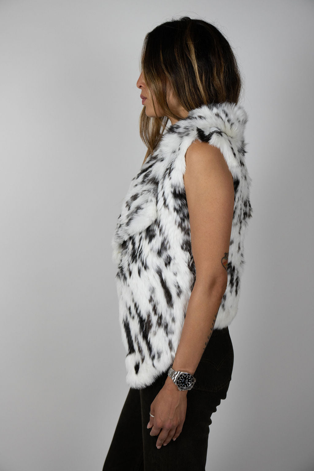 Angel Wings by Lucy rabbit fur vest in snow leopard print, sleeveless with high collar, shown on model side angles.