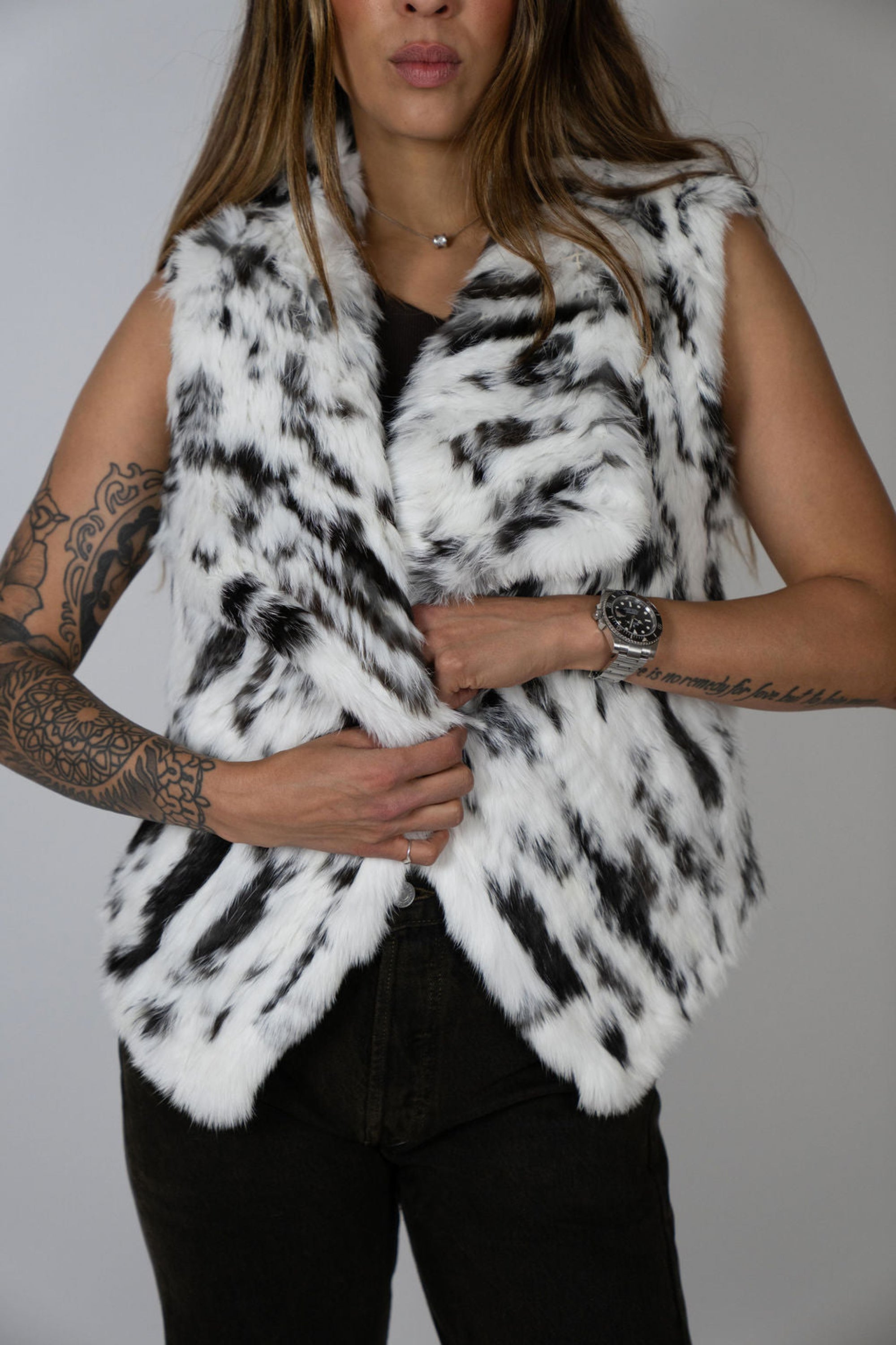 Angel Wings by Lucy rabbit fur vest in snow leopard print, sleeveless with high collar, shown on model close up.