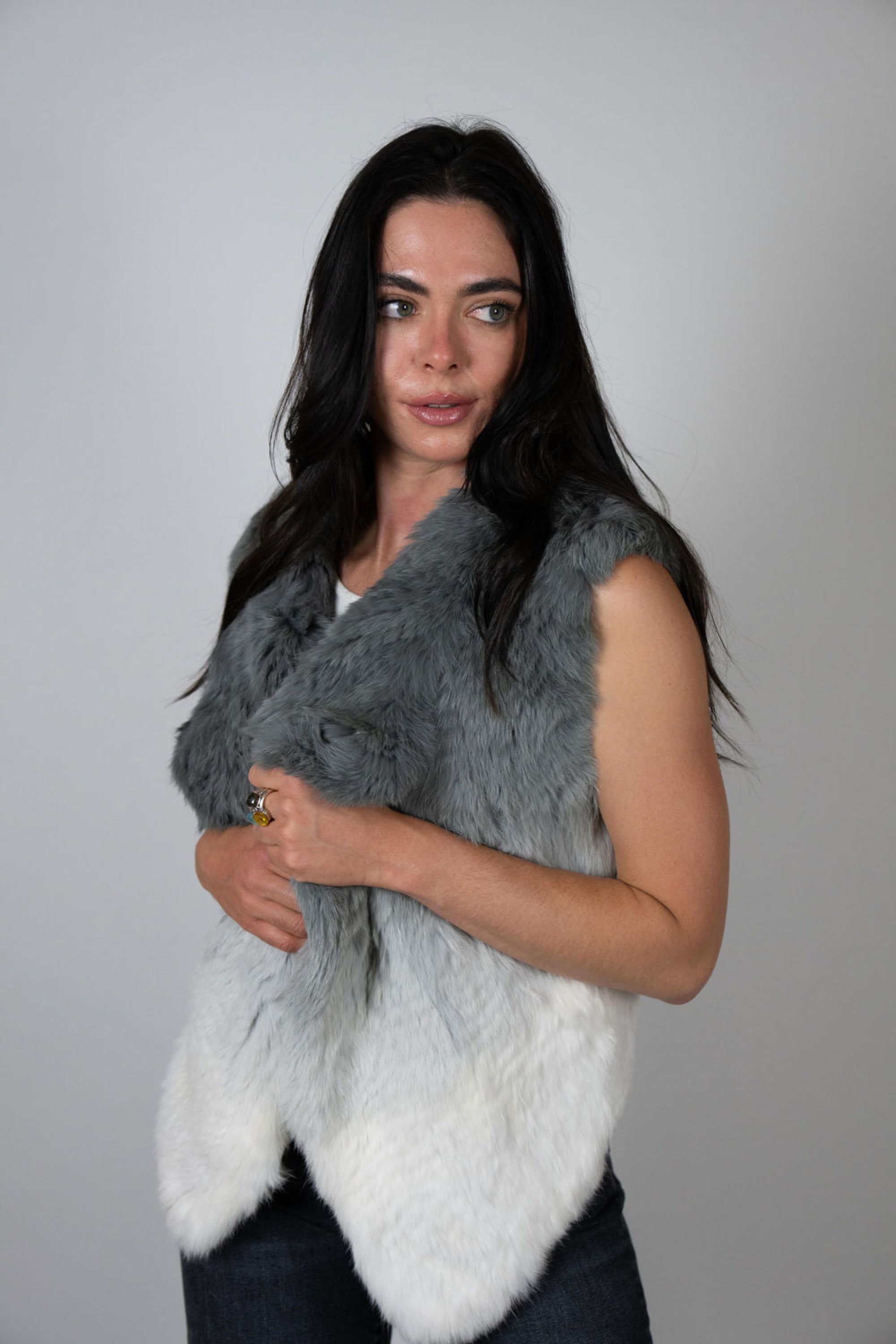 Angel Wings by Lucy rabbit fur vest in pale grey ombré, sleeveless and open-front, worn by model facing side.