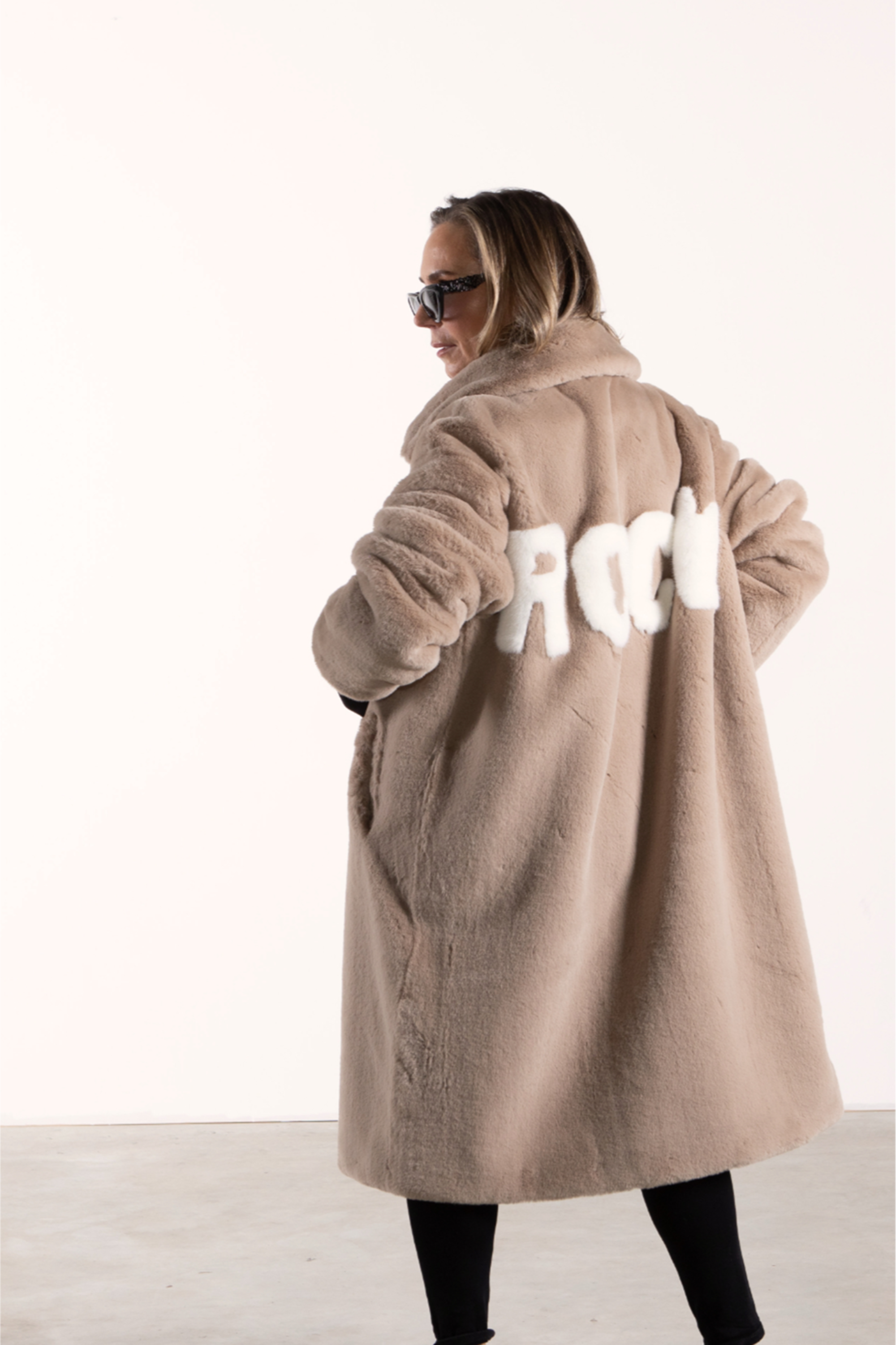 Three-quarter rear view of Angel Wings by Lucy Mr Greys ROCK Jacket – cozy mocca faux fur with graphic lettering