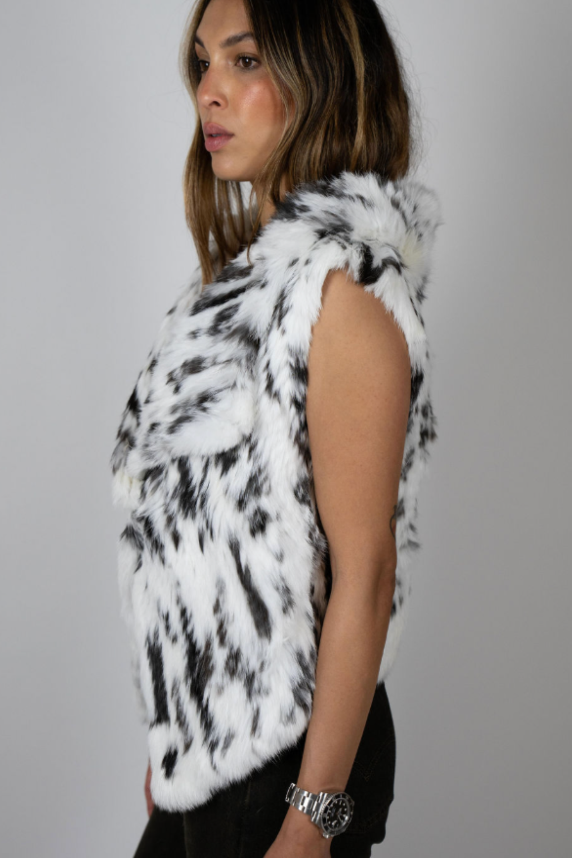 Angel Wings by Lucy rabbit fur vest in snow leopard print, sleeveless with high collar, shown on model side angles.