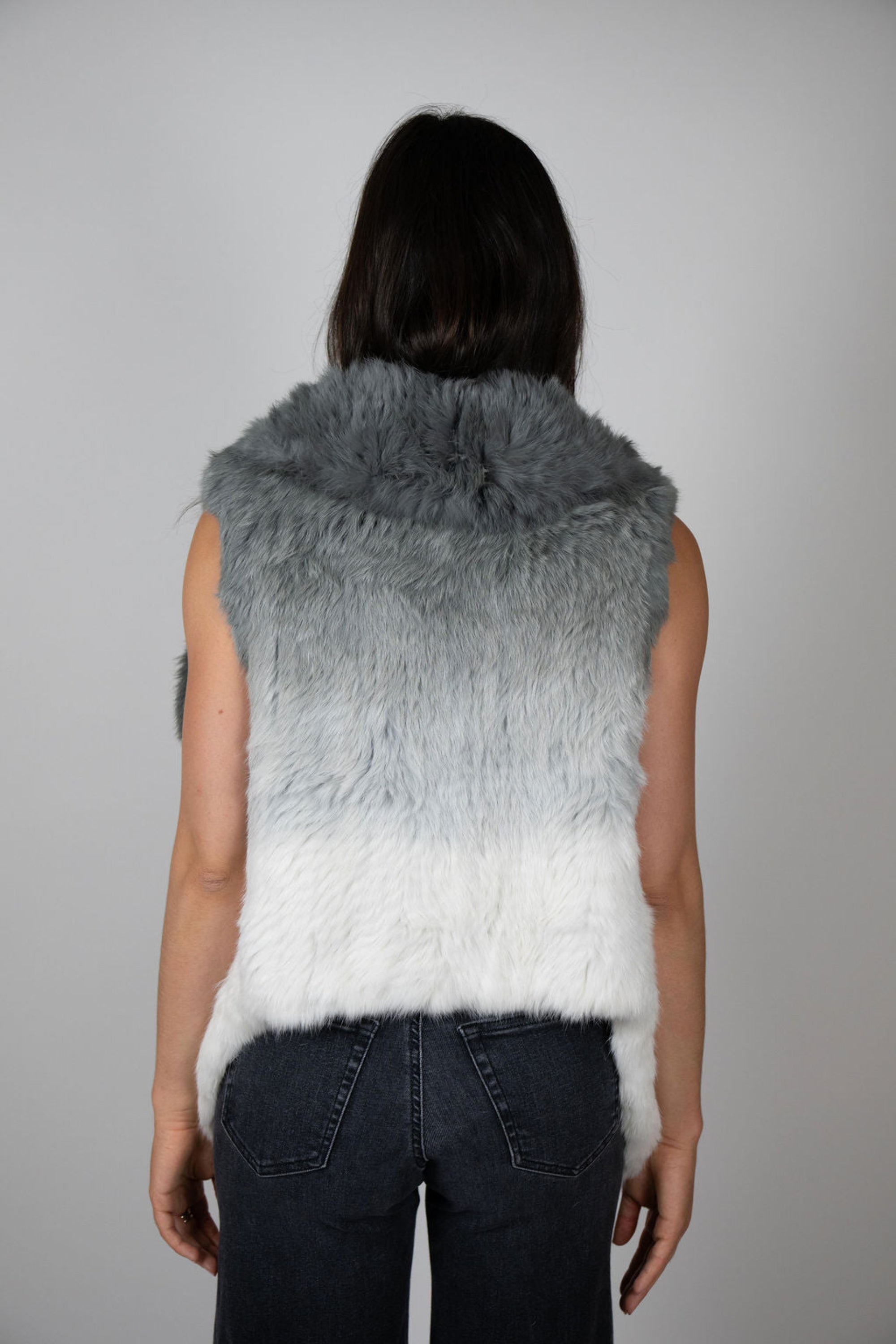 Angel Wings by Lucy rabbit fur vest in pale grey ombré, sleeveless and open-front, worn by model facing back.
