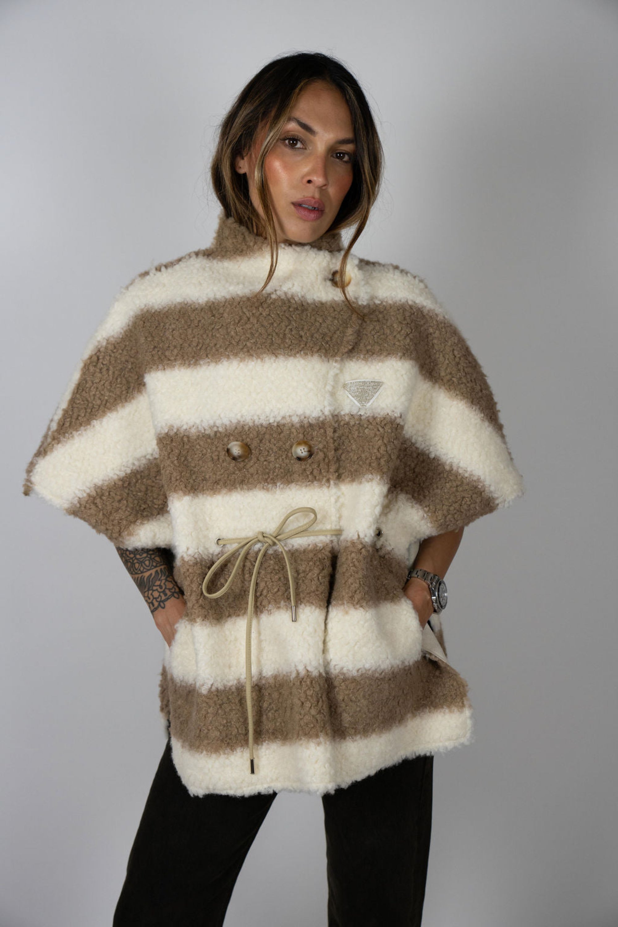 Angel Wings by Lucy wool cape called the manor cape in beige and ivory stripe, oversized with short sleeves, drawstring waist, and buttons, shown on model close up.