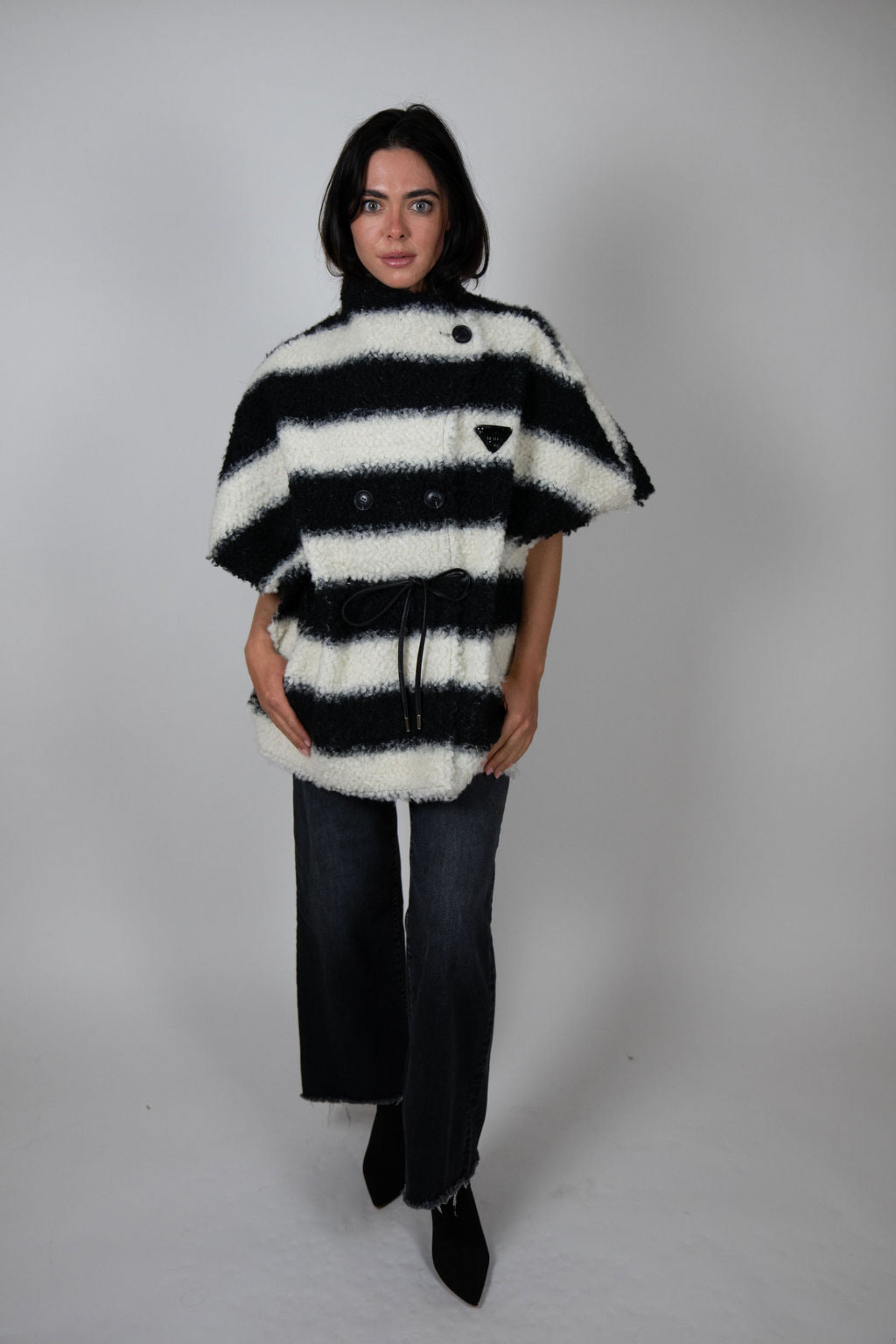 Angel Wings by Lucy black and white striped wool cape, oversized with short sleeves, buttons and drawstring waist, shown on model.