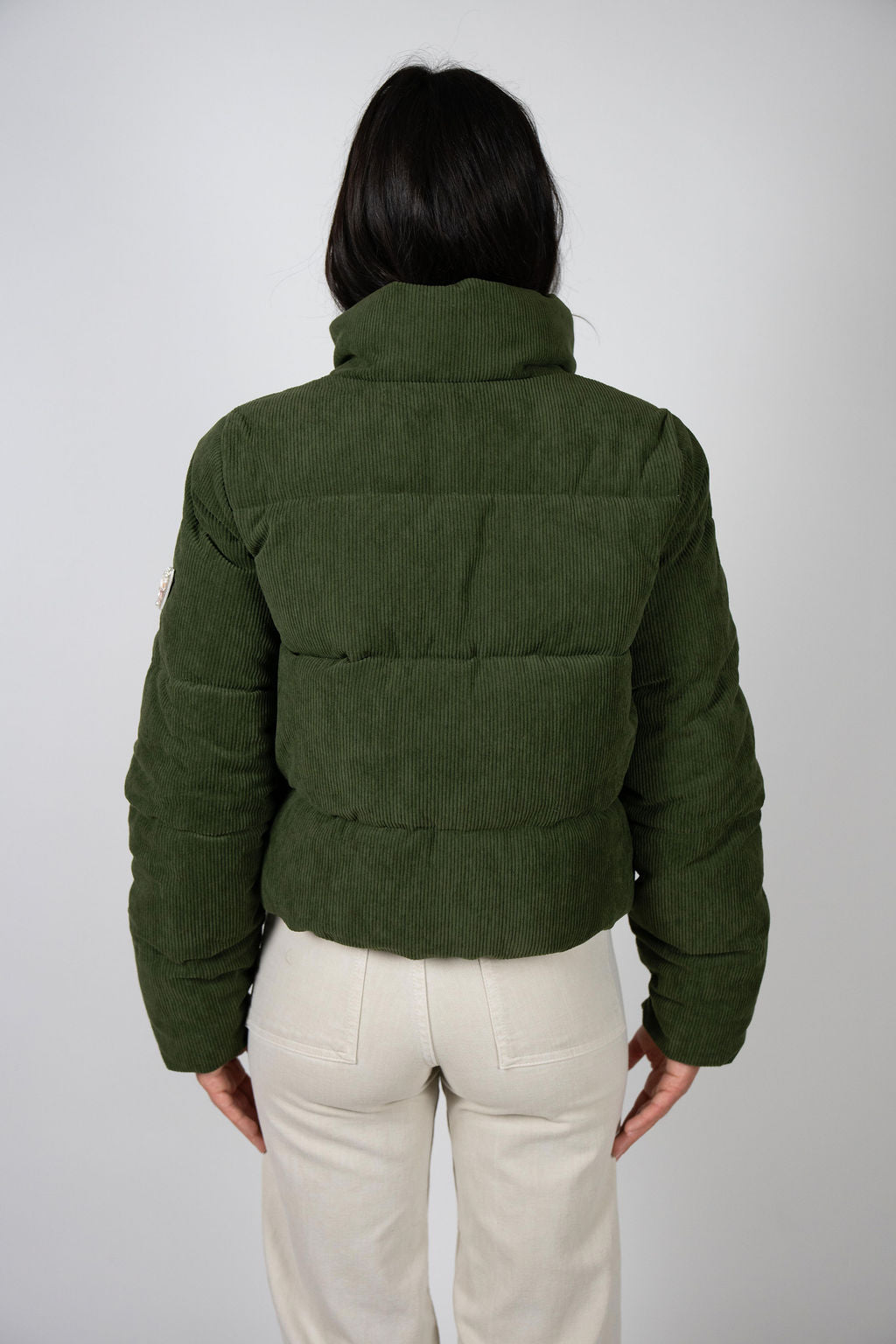 Back view of the Angel Wings Sundeck Jacket in olive, showing quilted paneling and collar.