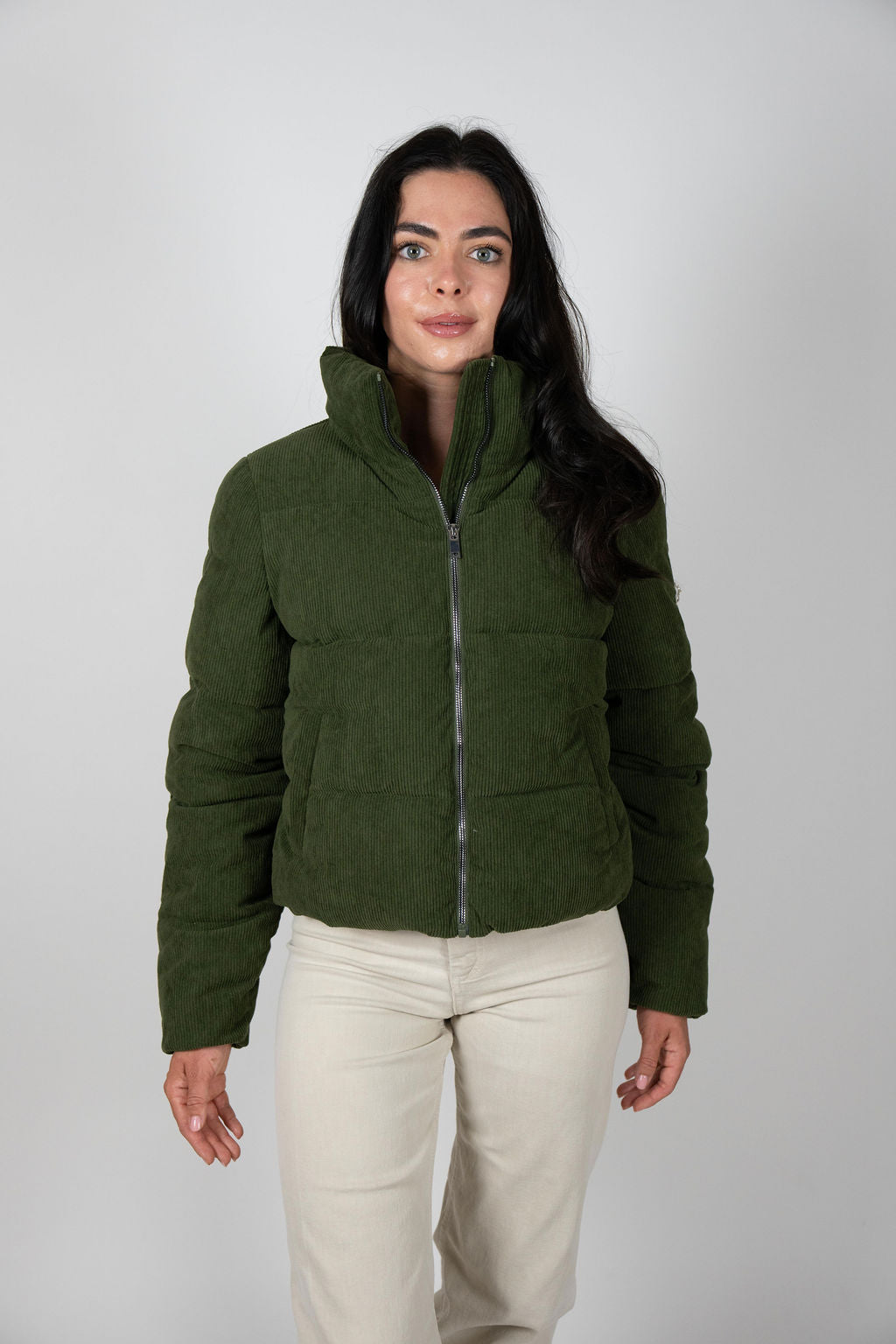 Model walking in olive Sundeck Jacket high neck detail