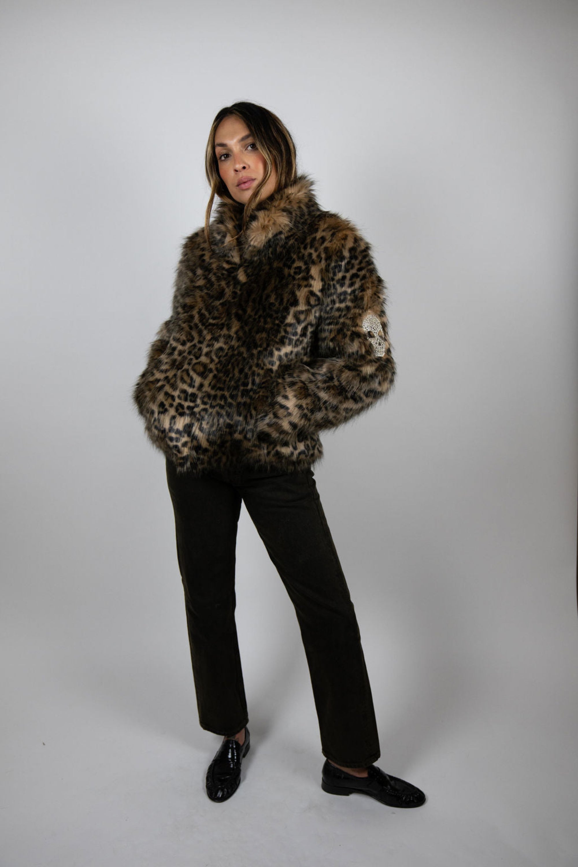 Full body view of model wearing Angel Wings by Lucy Leopard Crop with Skull Luxury Faux Fur Jacket – high-end women’s ski and après-ski style