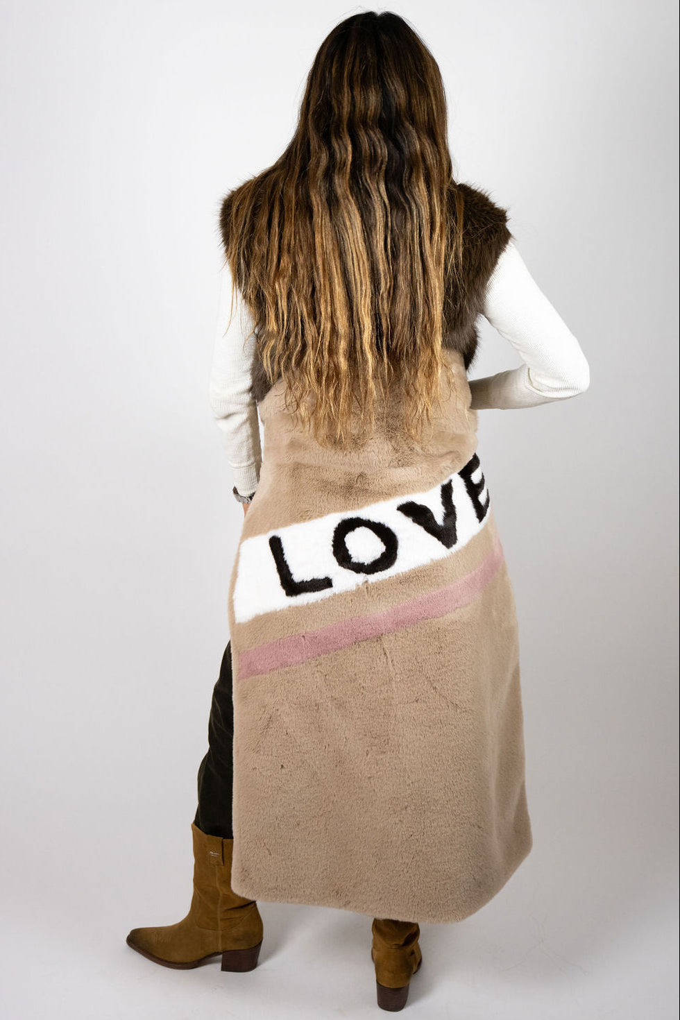 Close-up of LOVE artwork and blush stripe detail on the Mr Grey Love Beige faux-fur coat.