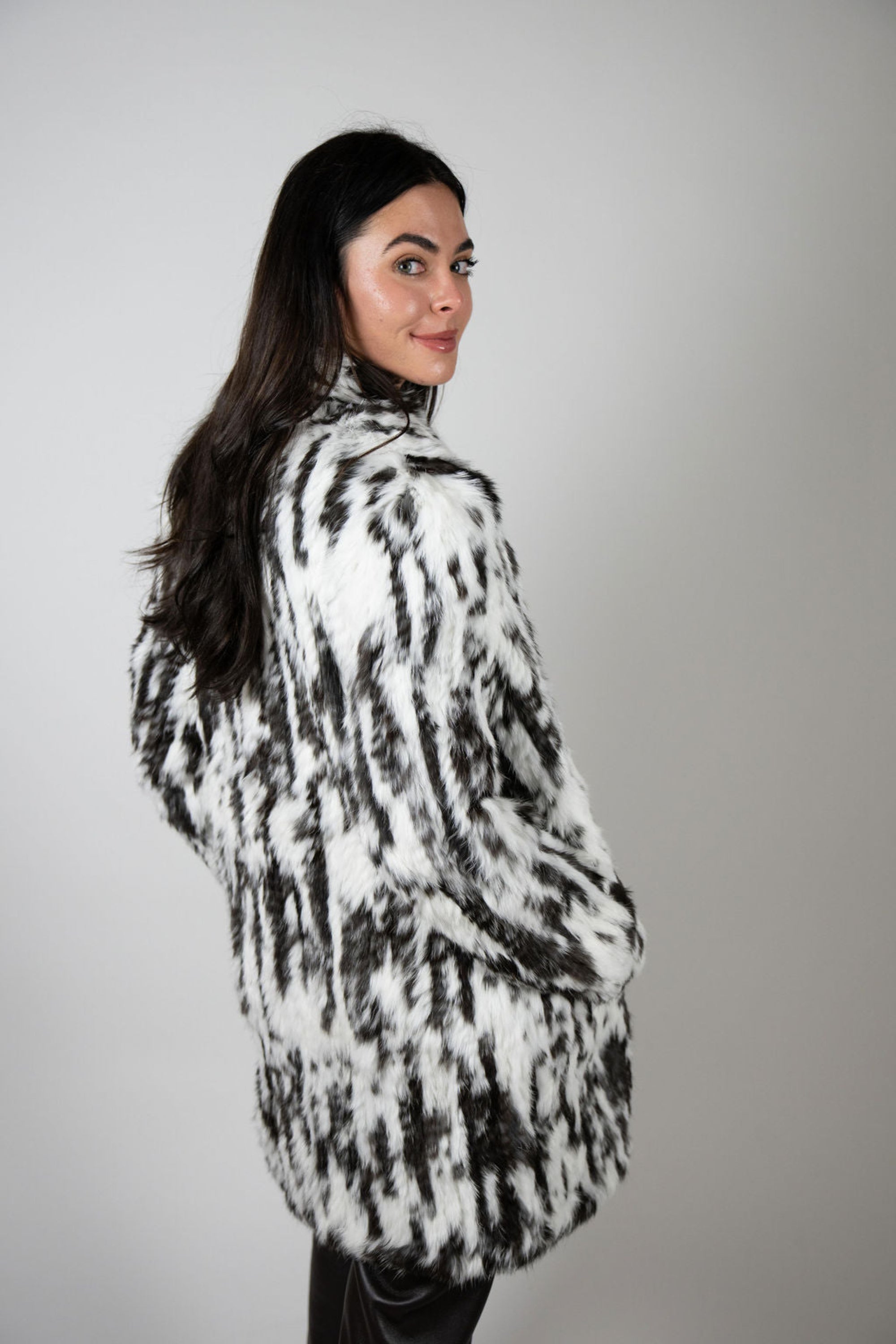 Side view of woman wearing the Rabbit Swing Coat in snow leop