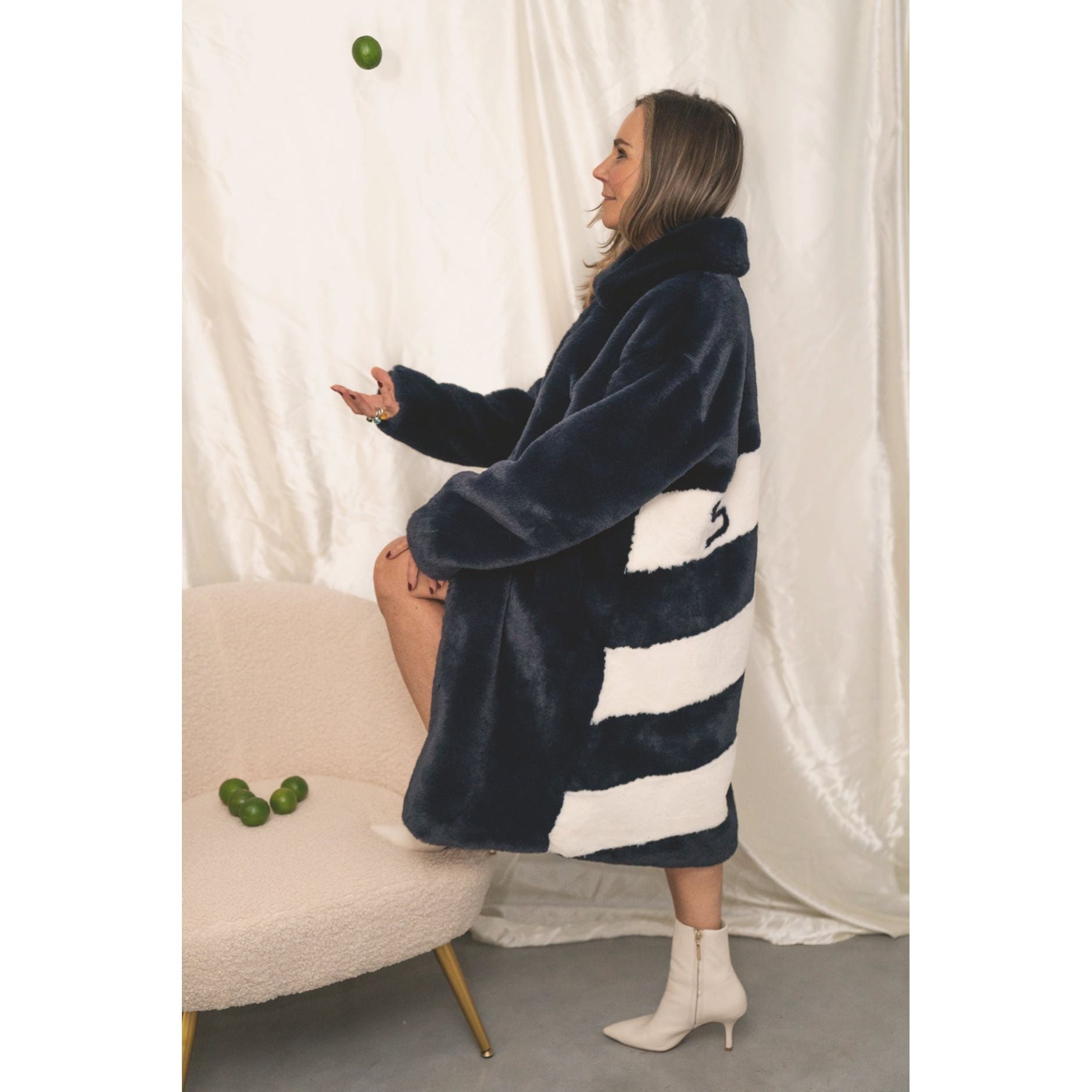 Back view of navy faux fur jacket with bold white diagonal stripes and “SKI” lettering — from the Mr. Greys collection.