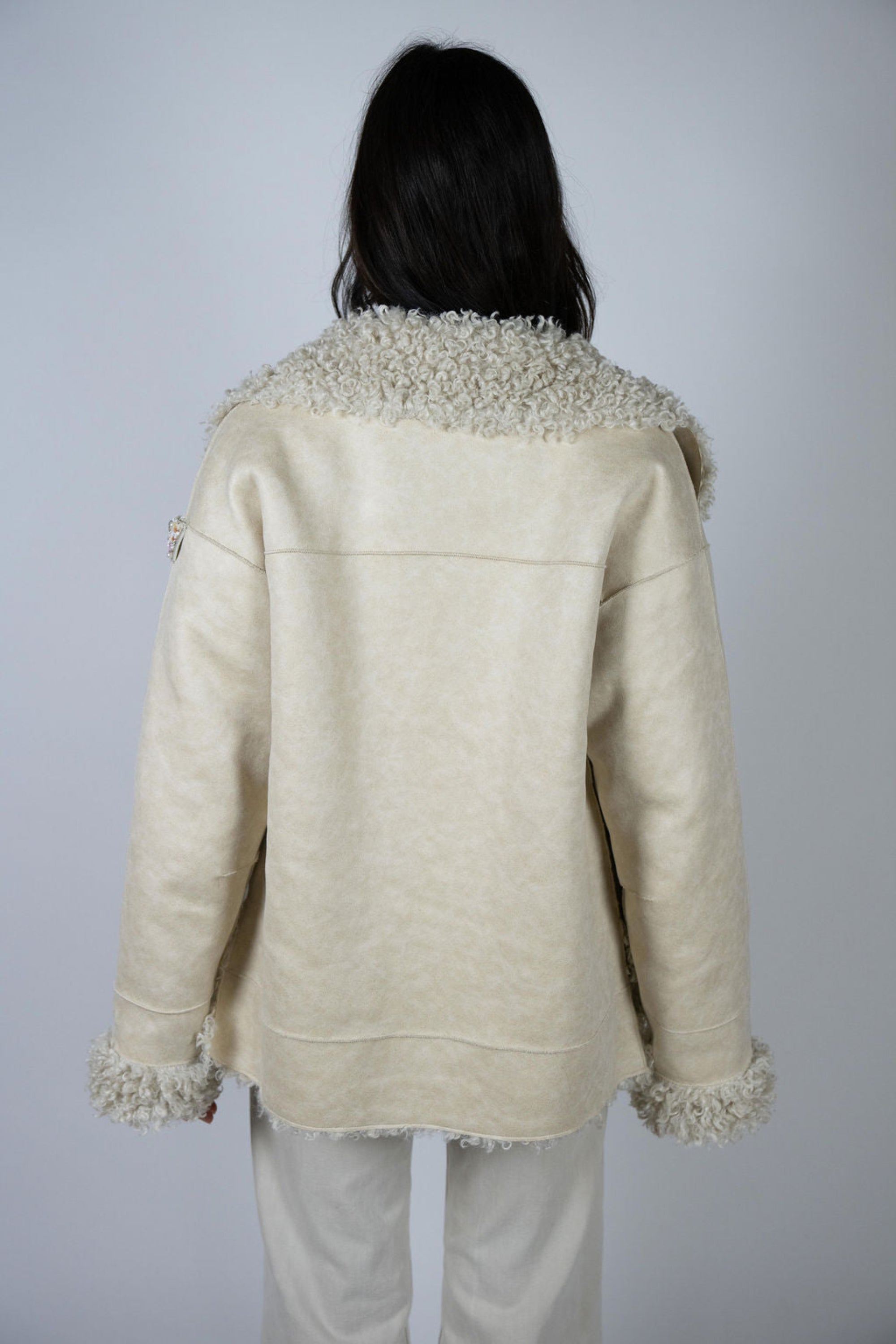 Back of the Angel Wings Two Arrows Shearling Jacket in cream, showing full fur paneling and relaxed fit.