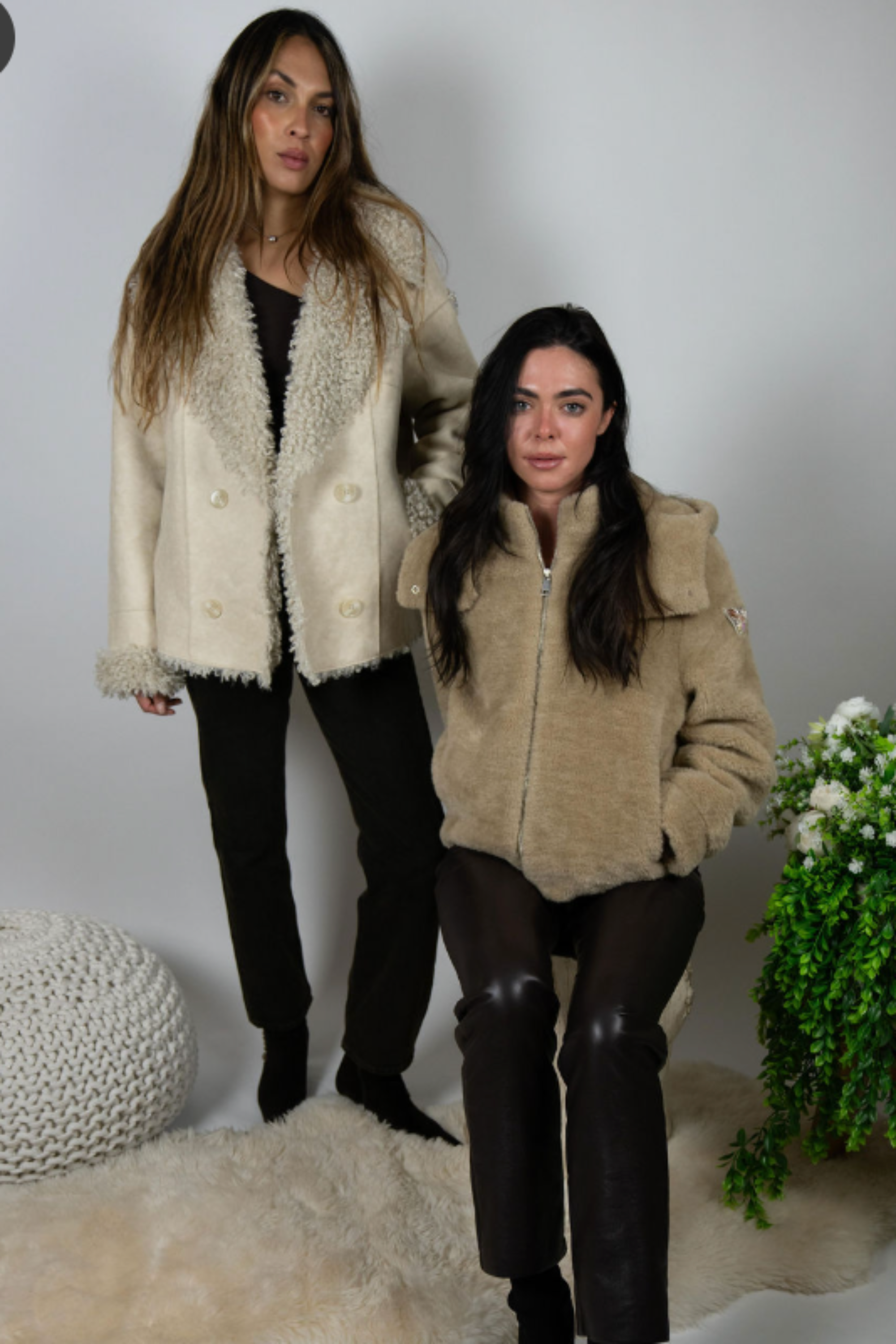 Two women styled in Angel Wings jackets, including cream Two Arrows Shearling, standing and seated.