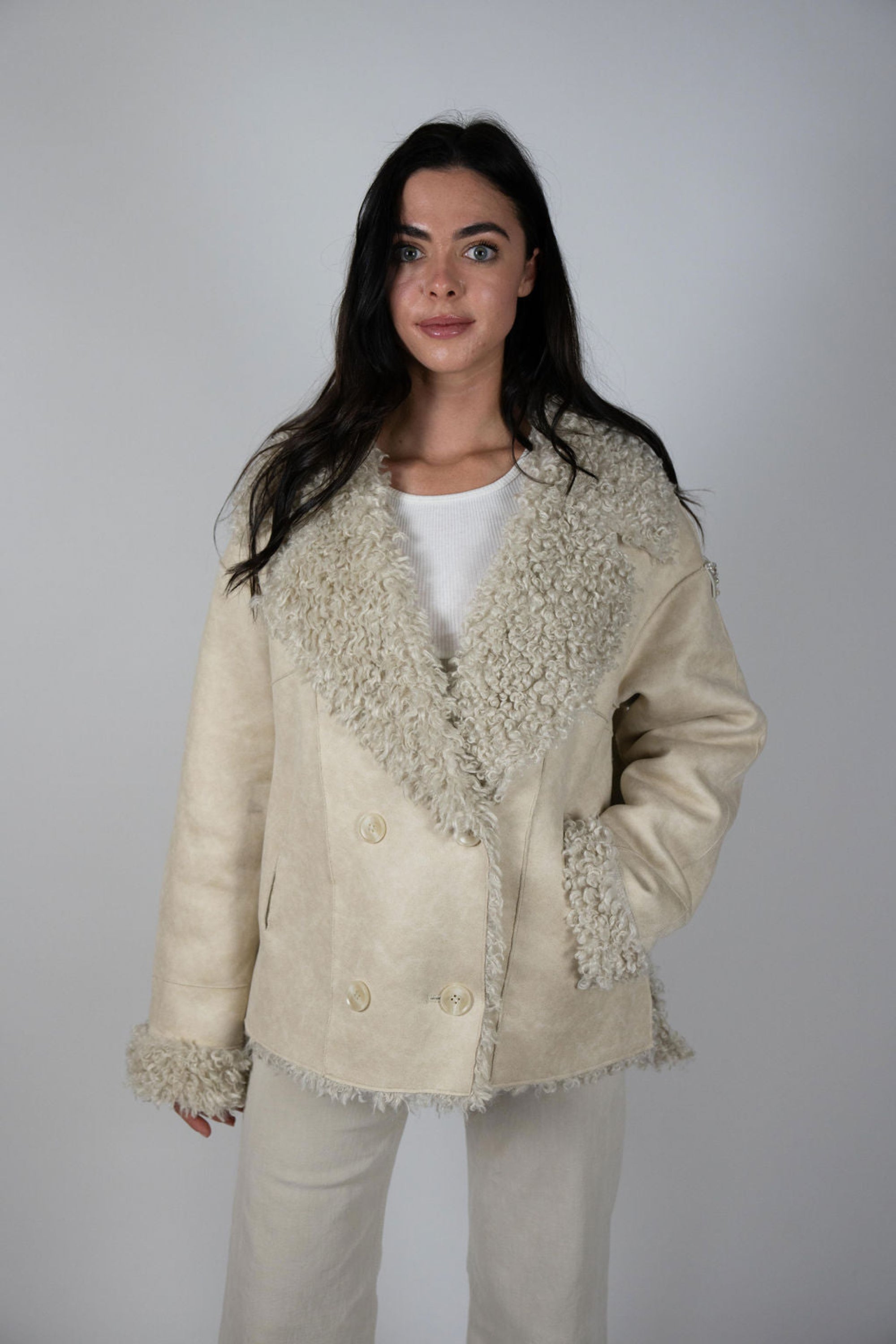 Woman wearing faux suede shearling jacket with double-breasted front and embellished triangle sleeve patch – Two Arrows Jacket by Angel Wings by Lucy