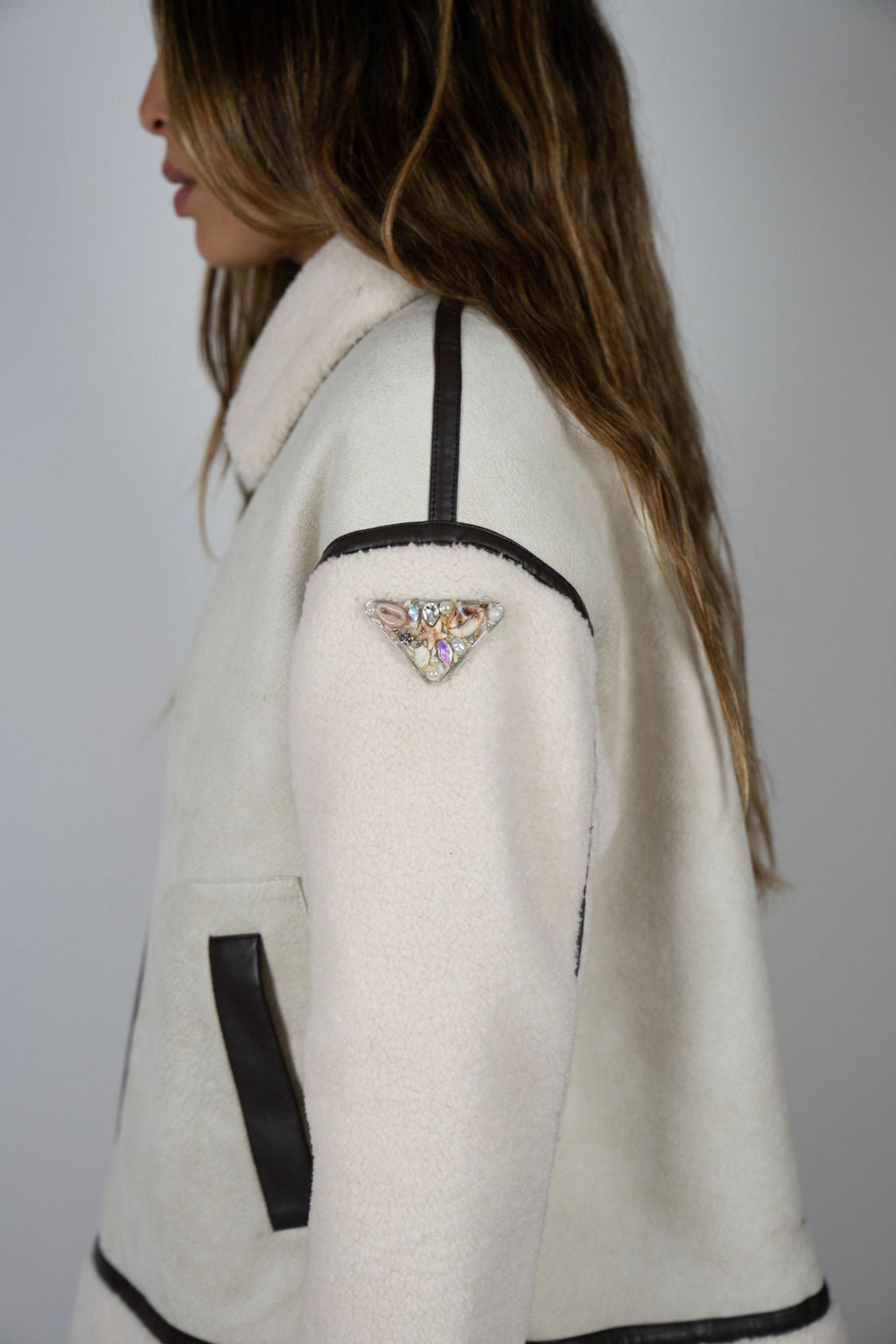 Model wearing Angel Wings Vandetta shearling jacket showing signature logo