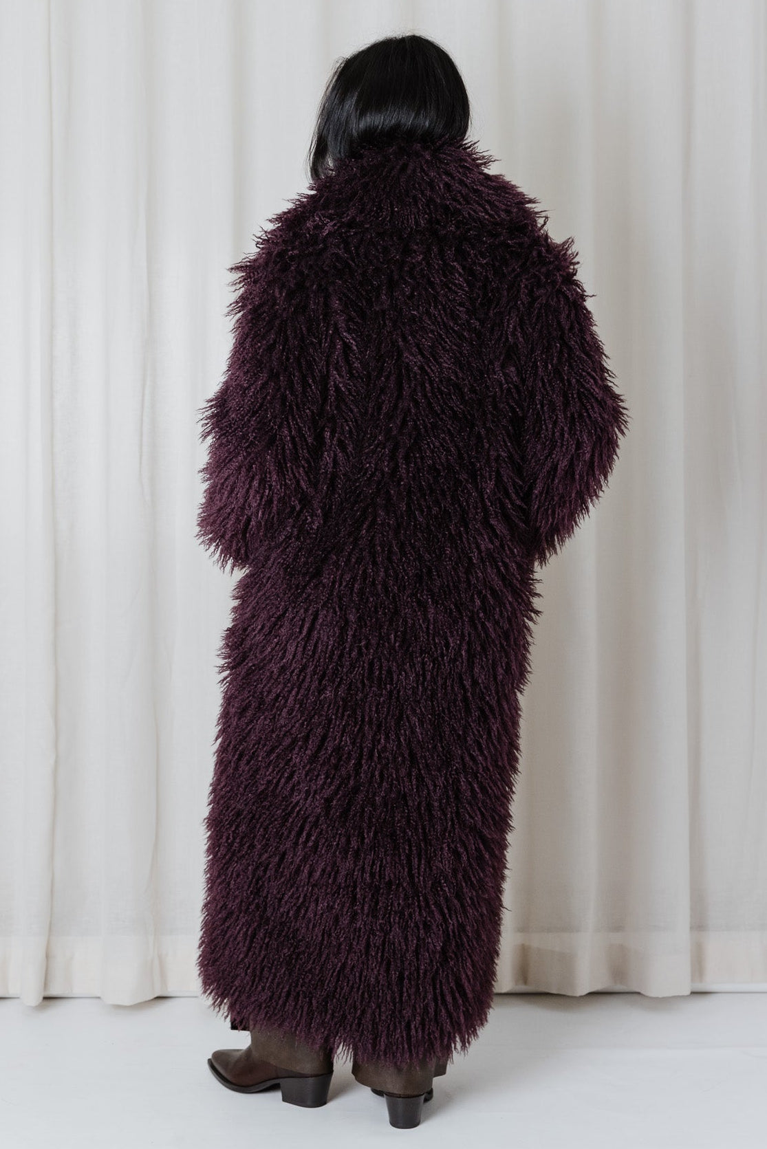 Back view of the Angel Wings Yeti Coat in Bordeaux, a long shaggy faux-fur statement coat.