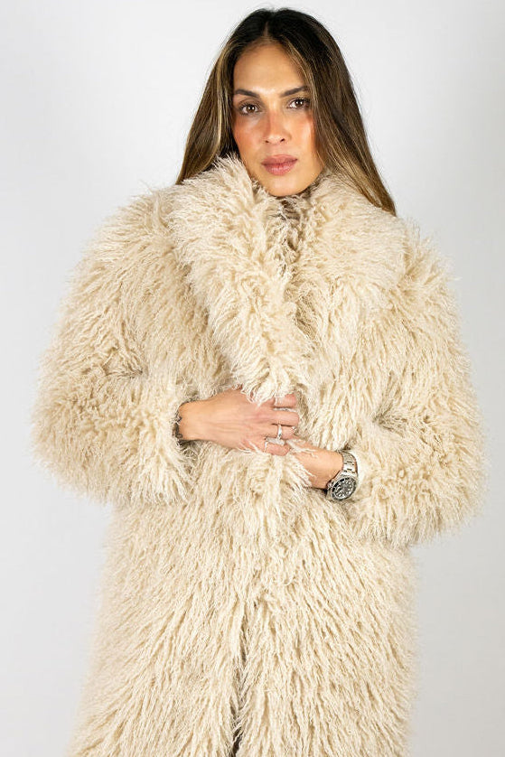 Front detail of the Angel Wings Yeti Coat in Oat showing its oversized shaggy faux fur and statement collar.
