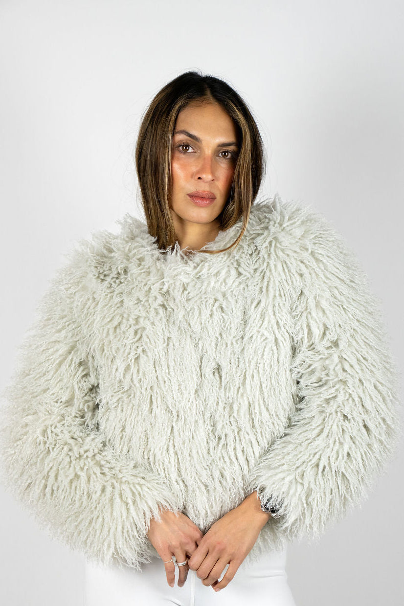 Model wearing the Angel Wings Yeti Jacket in Grey, a short shaggy faux-fur statement jacket.