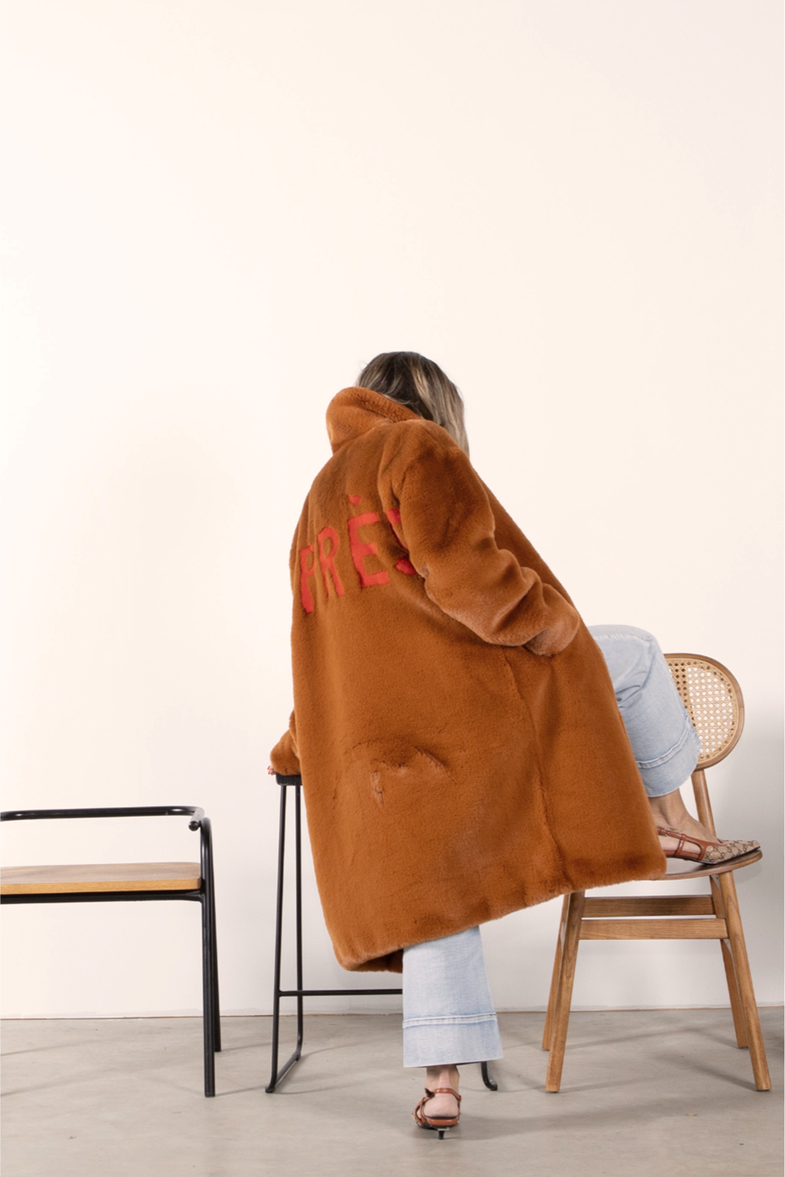 Back view of caramel faux fur jacket with bold red “APRÈS” lettering — part of the Mr. Greys après-ski collection.
