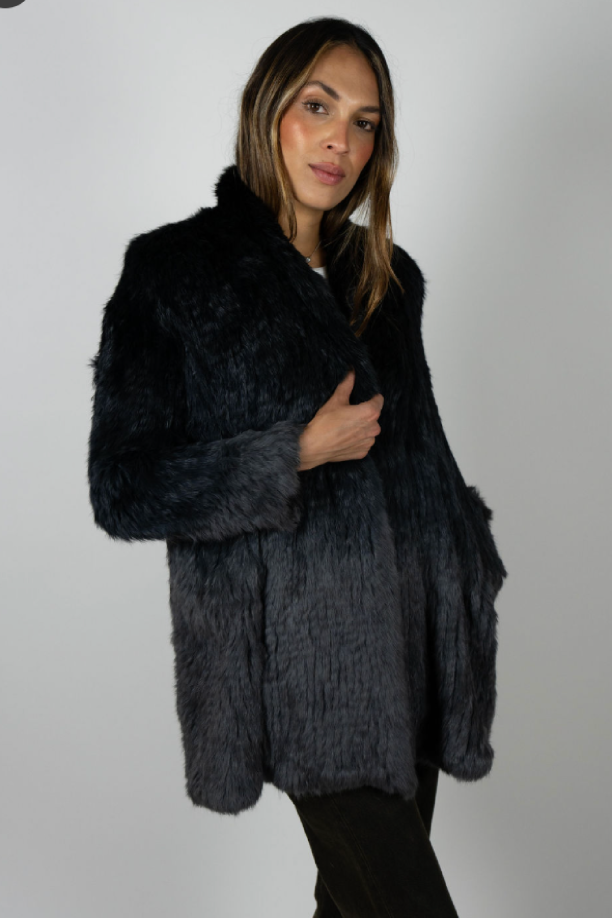 Model in angled front pose holding lapel of Rabbit Dip Dye Black Charcoal swing jacket