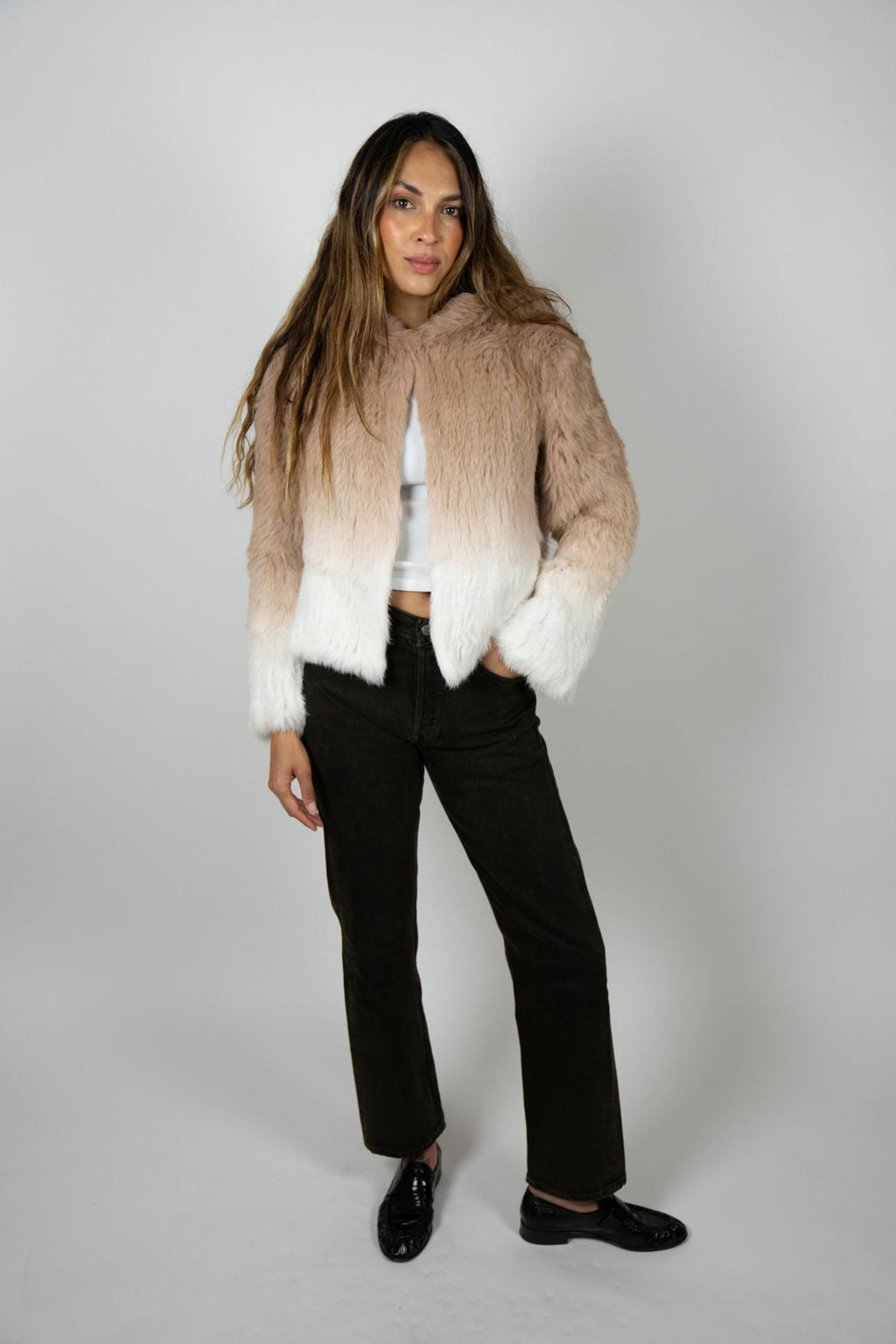 Model wearing beige ombre rabbit fur crop jacket with hood, front view