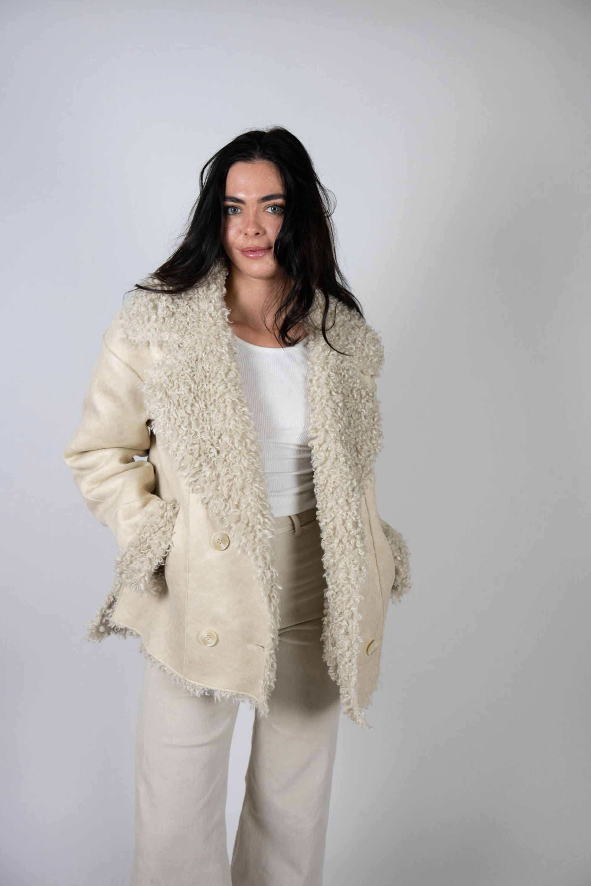 Woman wearing faux suede shearling jacket with double-breasted front and embellished triangle sleeve patch – Two Arrows Jacket by Angel Wings by Lucy