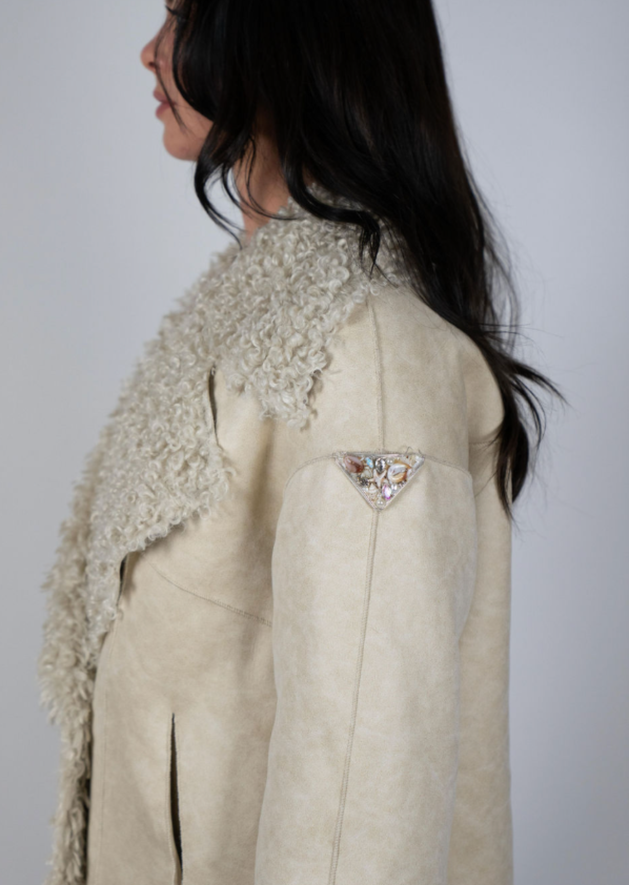 Woman wearing faux suede shearling jacket with double-breasted front and embellished triangle sleeve patch – Two Arrows Jacket by Angel Wings by Lucy