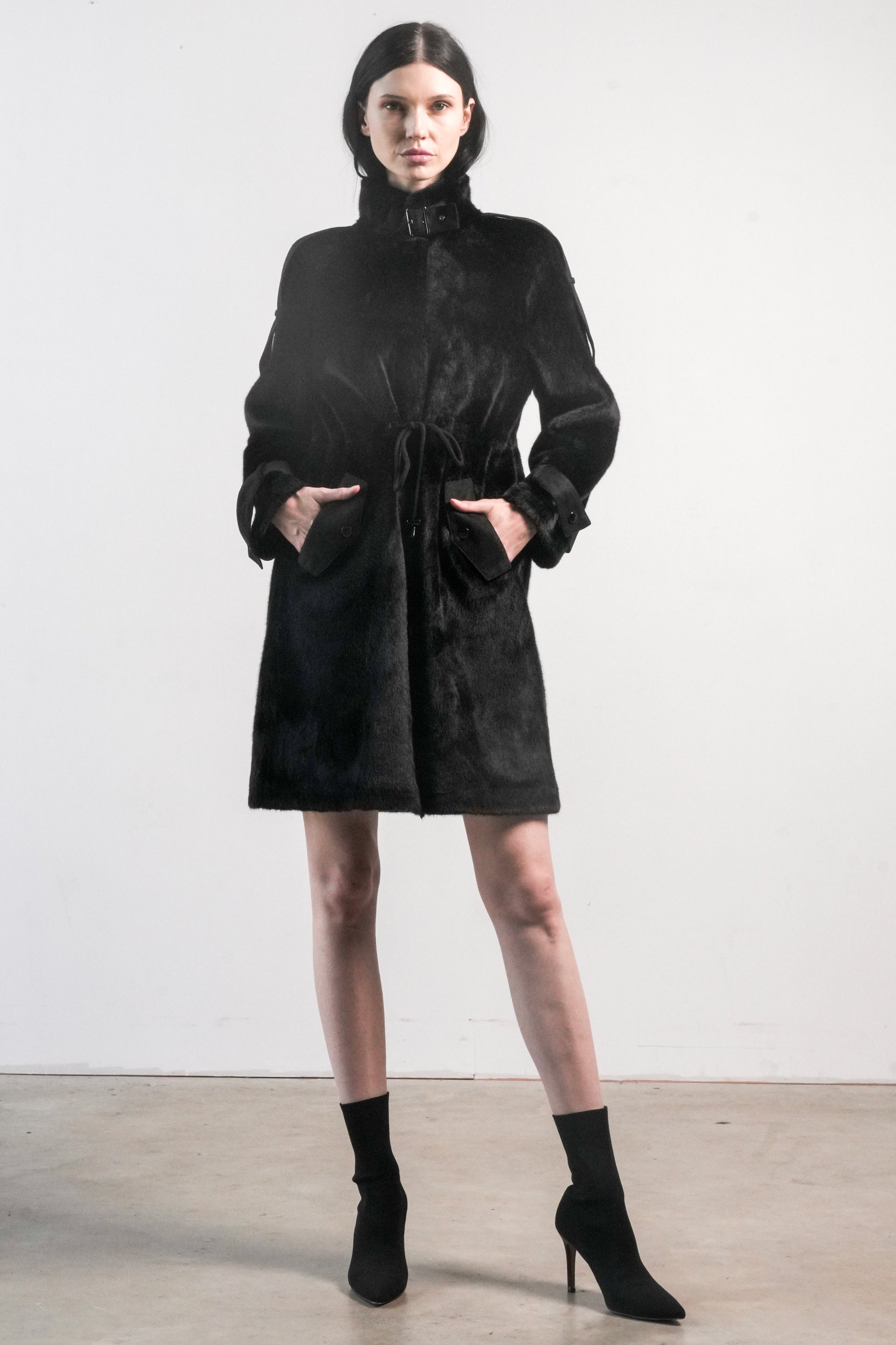 Front view of black faux fur jacket with high collar, drawstring waist, and tonal suede trim — Chica Chica style in Black.