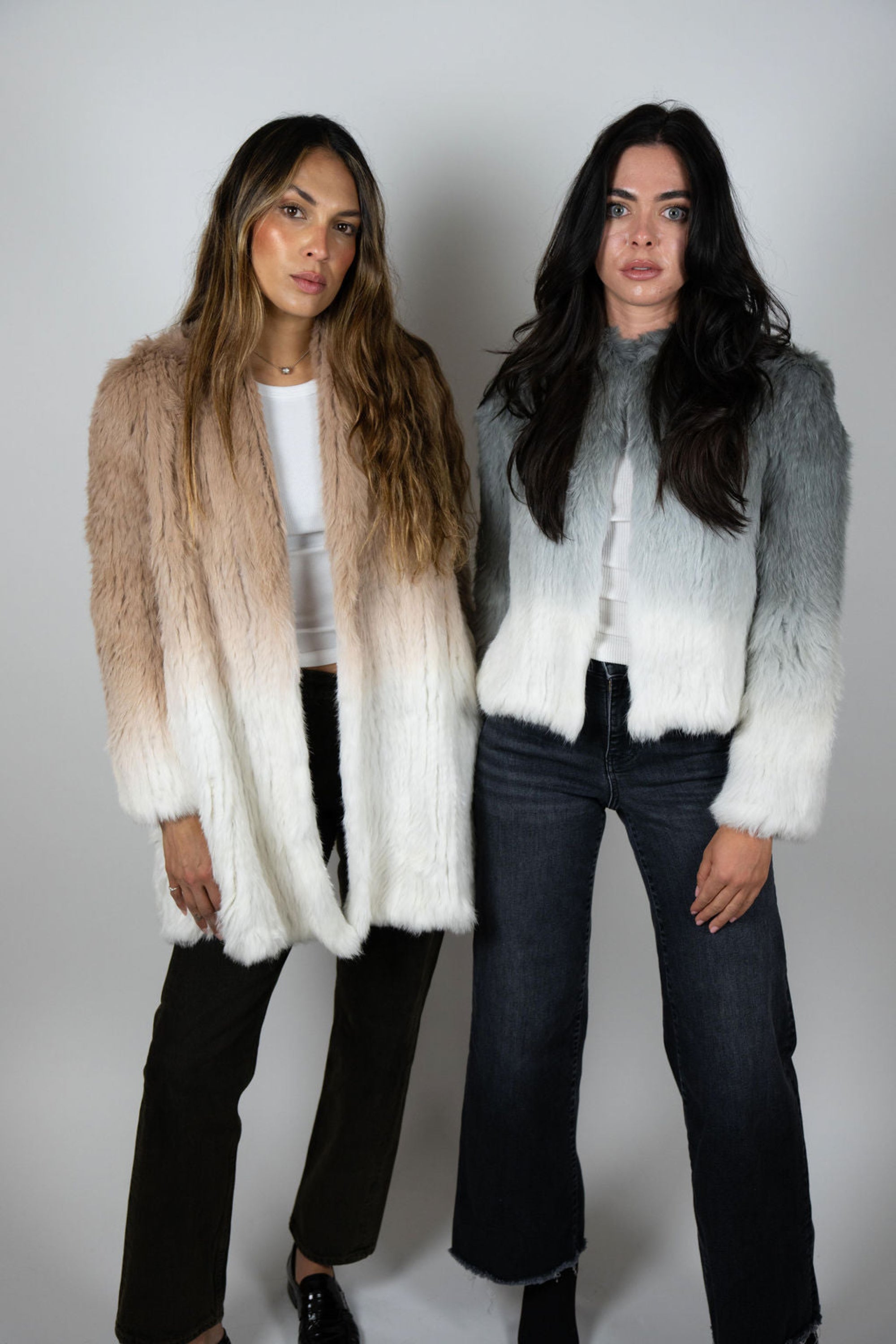 Model duo wearing beige and grey ombre rabbit fur coats side by side