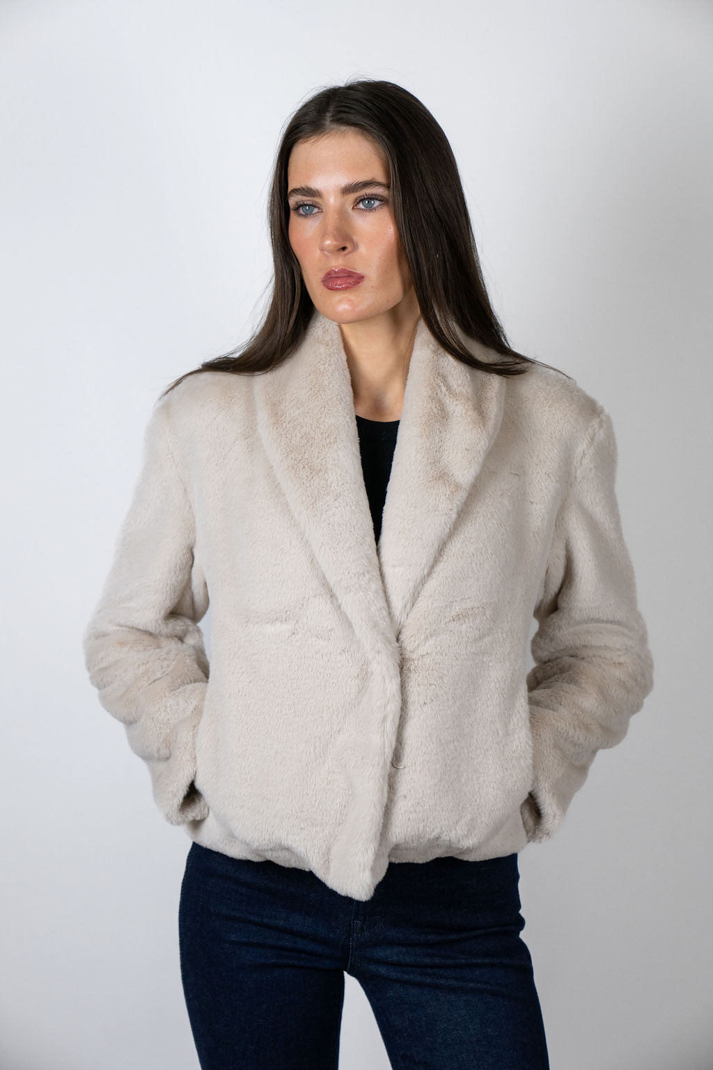 Model wearing the Bear Den Crop Jacket in Beige by Angel Wings by Lucy, a luxury faux fur cropped jacket designed for versatile winter styling.