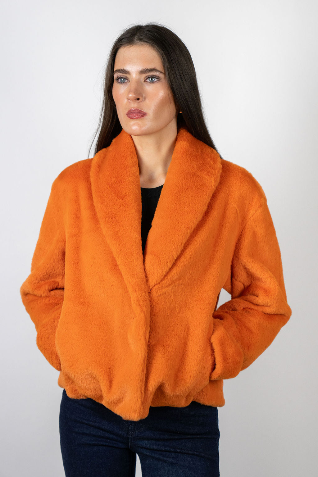 Model wearing the Bear Den Crop Jacket in Coral by Angel Wings by Lucy, a luxury faux fur cropped jacket designed for bold winter styling.