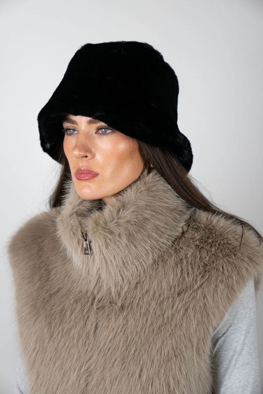 Model wearing the Bucket Hat in Black by Angel Wings by Lucy, a modern cold-weather accessory designed for elevated winter styling.