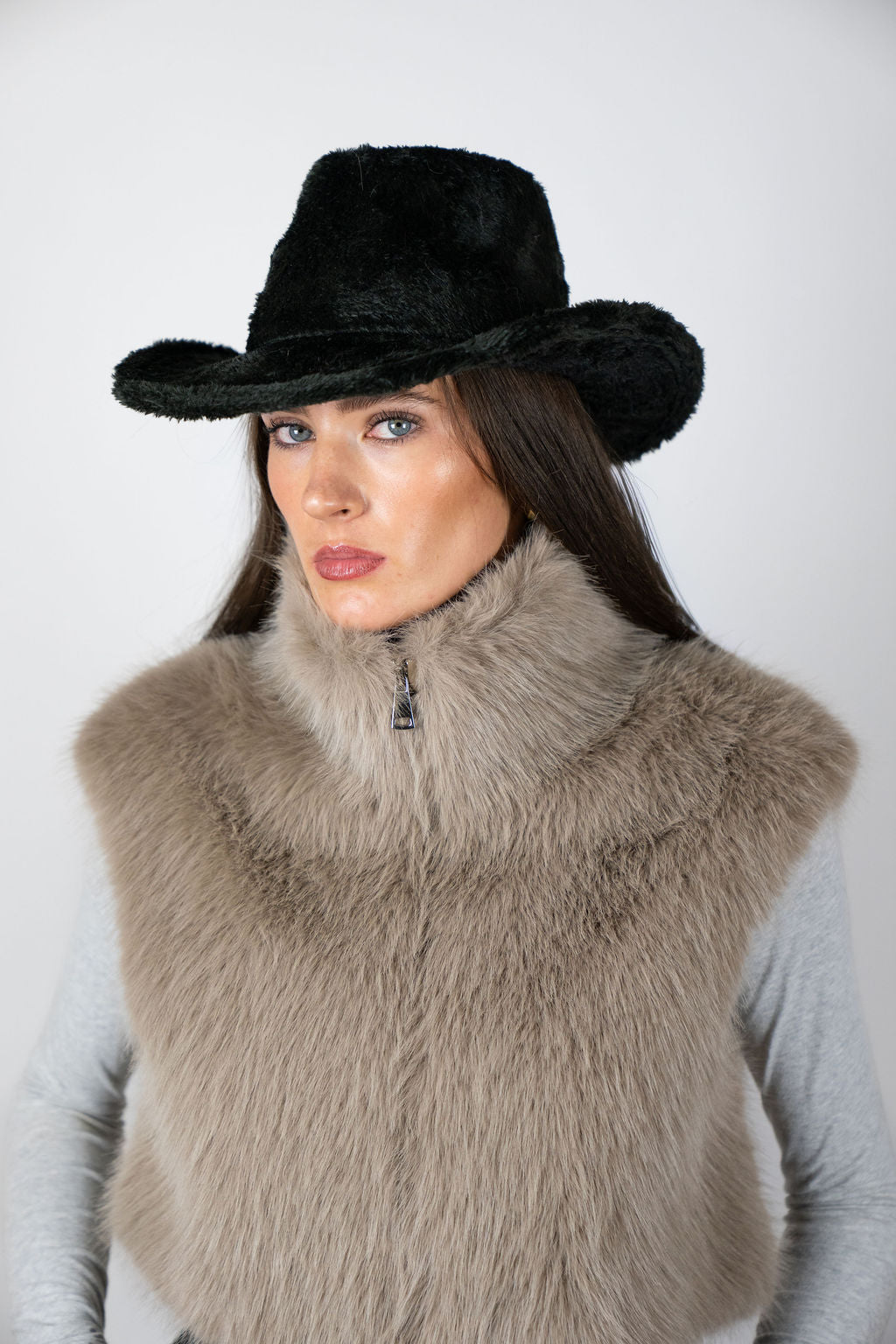 Model wearing the Cowboy Hat in Black by Angel Wings by Lucy, styled with a faux fur vest for elevated western-inspired winter dressing.