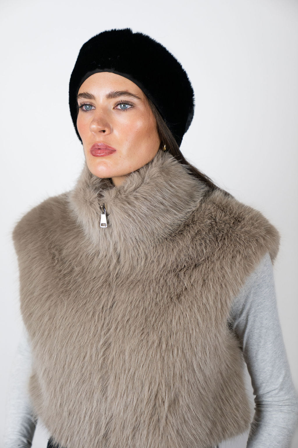 Model wearing the faux fur headband in Black by Angel Wings by Lucy, styled with a faux fur vest for elevated winter accessorising.